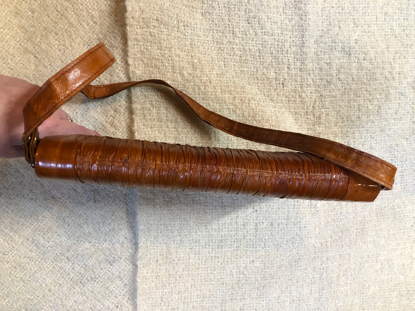 Kingspier Vintage - Vintage satchel in very soft caramel colour leather with gathered leather details, a unique front clasp, brass hardware and three inside compartments. 
Length - 12”
Width - 1”
Height - 7.5”
Strap - 30.5”
This purse is in excellent condition.