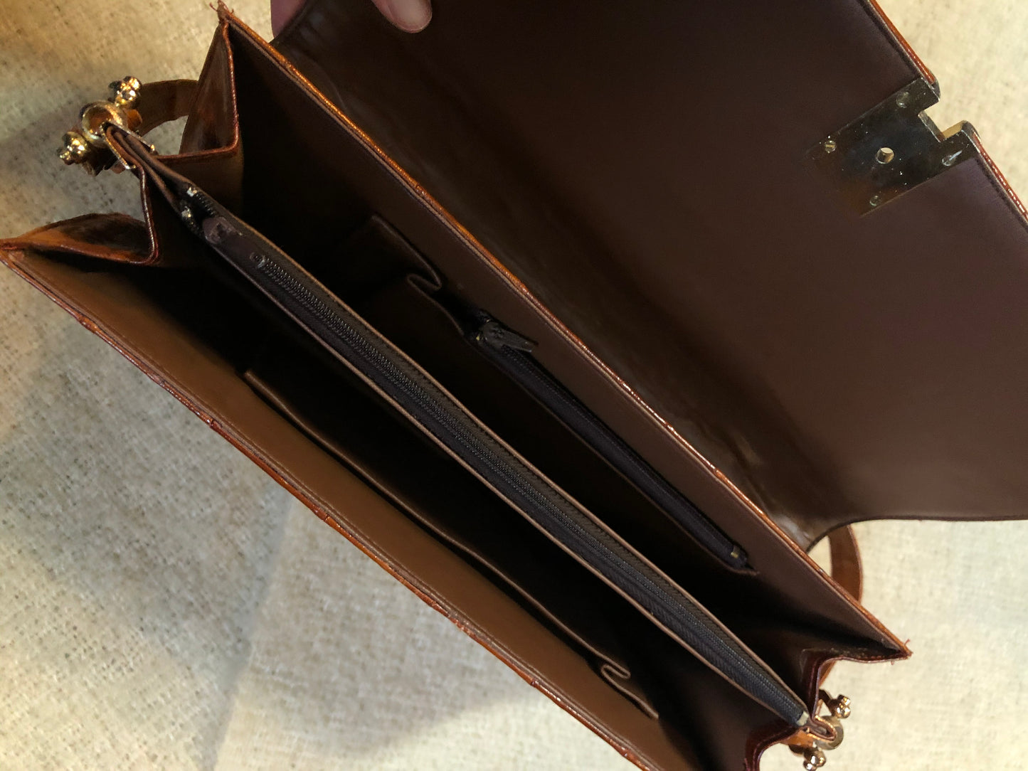 Kingspier Vintage - Vintage satchel in very soft caramel colour leather with gathered leather details, a unique front clasp, brass hardware and three inside compartments. 
Length - 12”
Width - 1”
Height - 7.5”
Strap - 30.5”
This purse is in excellent condition.