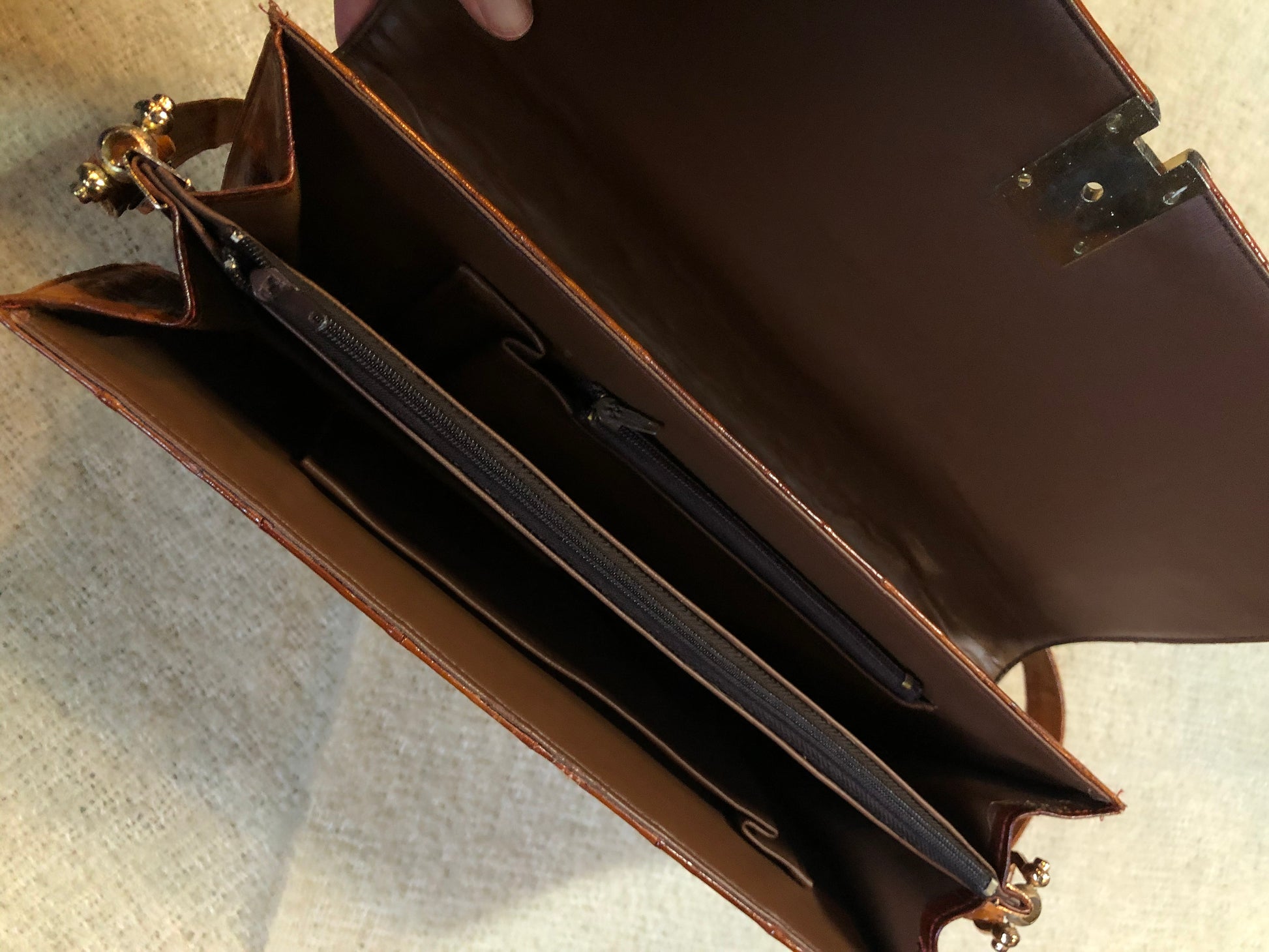 Kingspier Vintage - Vintage satchel in very soft caramel colour leather with gathered leather details, a unique front clasp, brass hardware and three inside compartments. 
Length - 12”
Width - 1”
Height - 7.5”
Strap - 30.5”
This purse is in excellent condition.