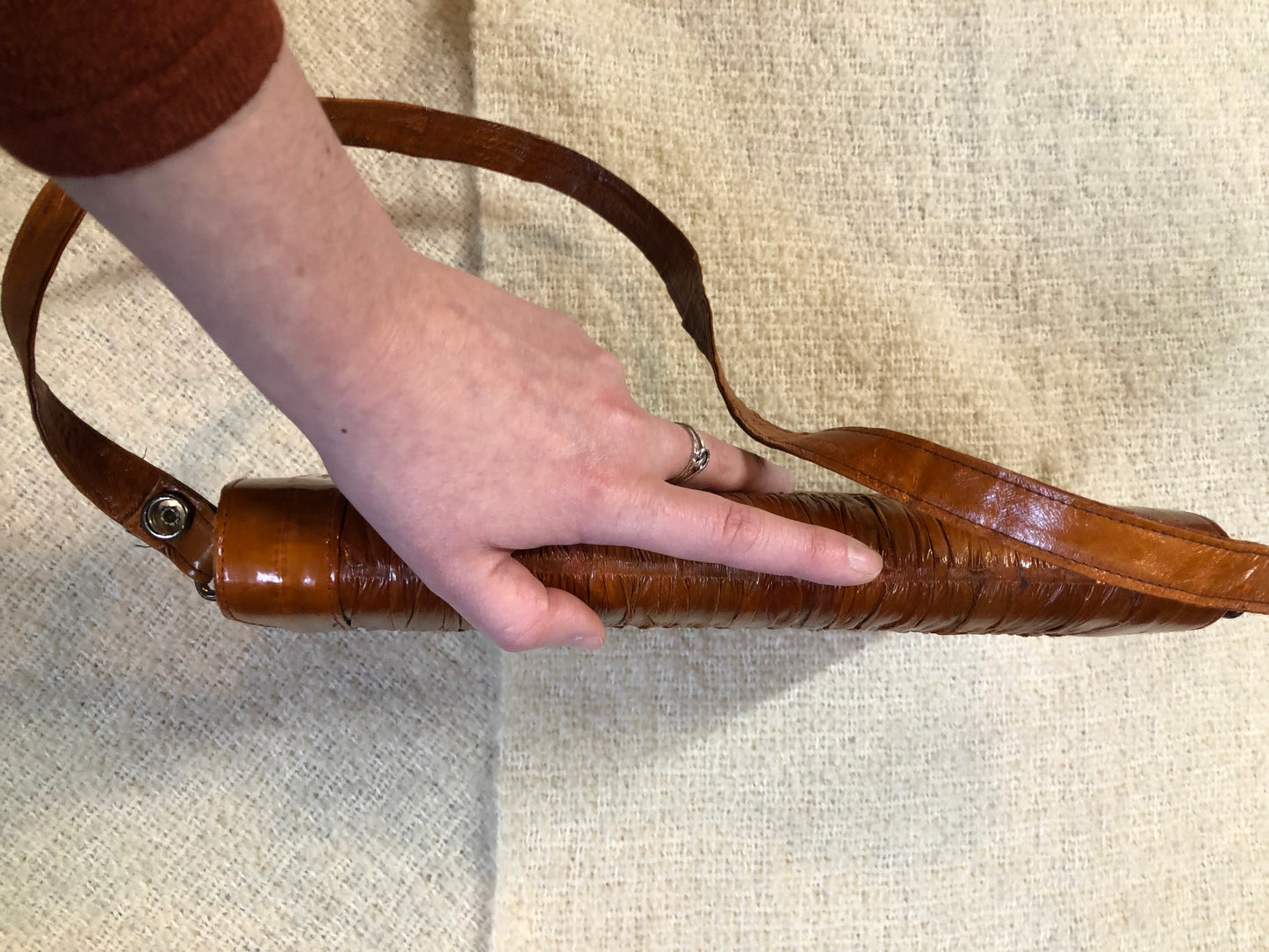 Kingspier Vintage - Vintage satchel in very soft caramel colour leather with gathered leather details, a unique front clasp, brass hardware and three inside compartments. 
Length - 12”
Width - 1”
Height - 7.5”
Strap - 30.5”
This purse is in excellent condition.