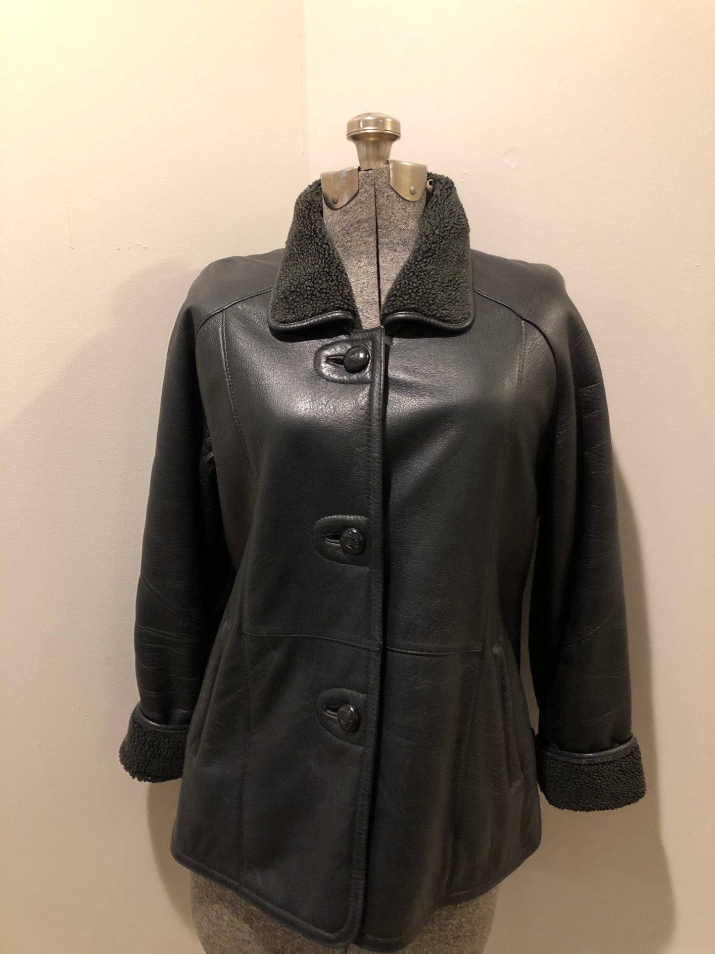 Kingspier Vintage - Contemporary black leather flight style jacket with synthetic wool pile lining , button closures and slash pockets.