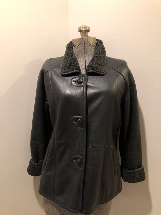Kingspier Vintage - Contemporary black leather flight style jacket with synthetic wool pile lining , button closures and slash pockets.