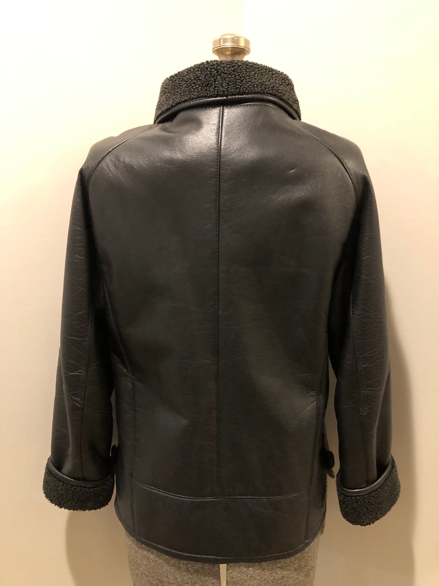 Kingspier Vintage - Contemporary black leather flight style jacket with synthetic wool pile lining , button closures and slash pockets.