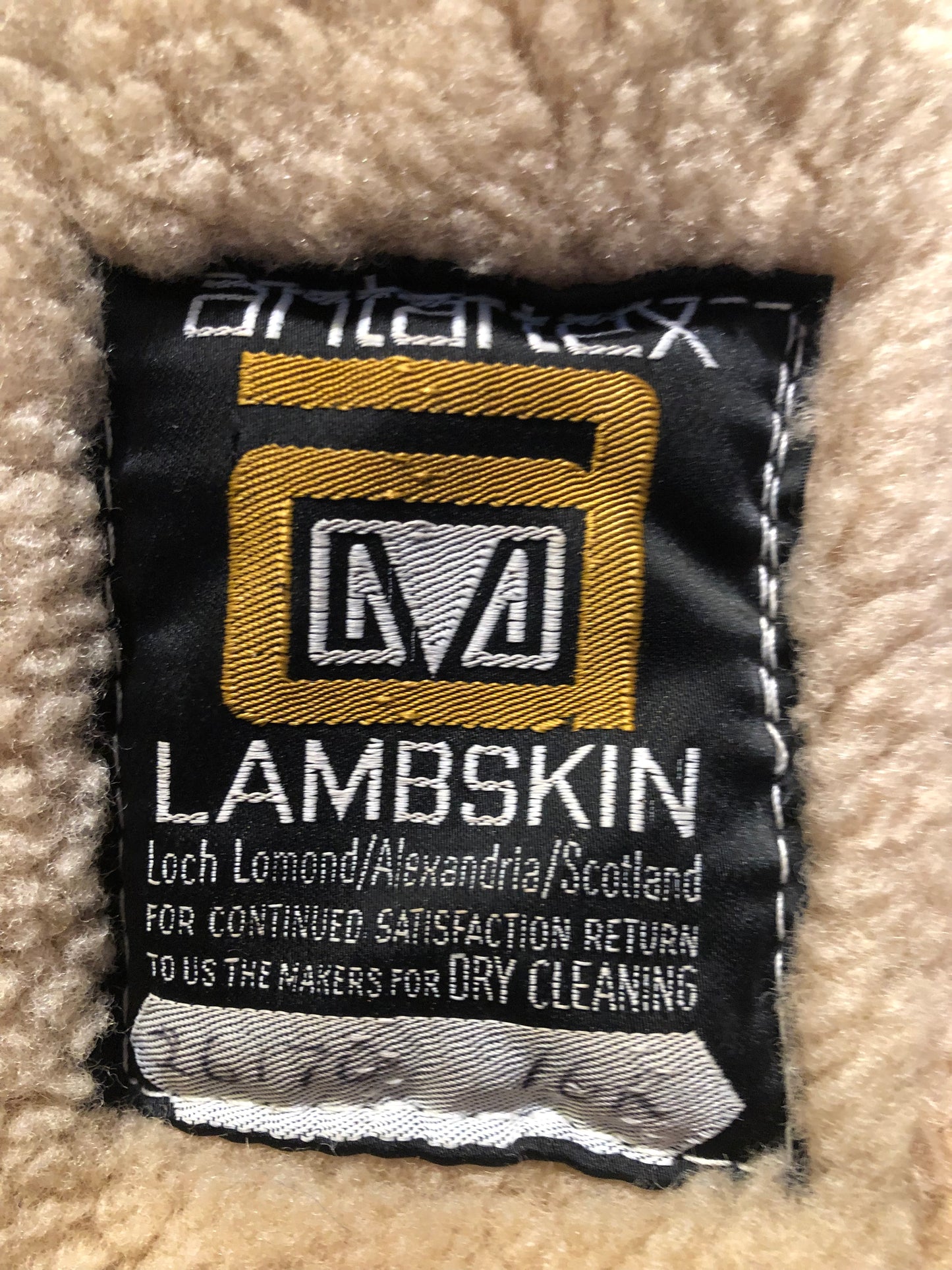 Vintage Antarrex Mongolian lambskin full length shearling coat with button closures and two front pockets.