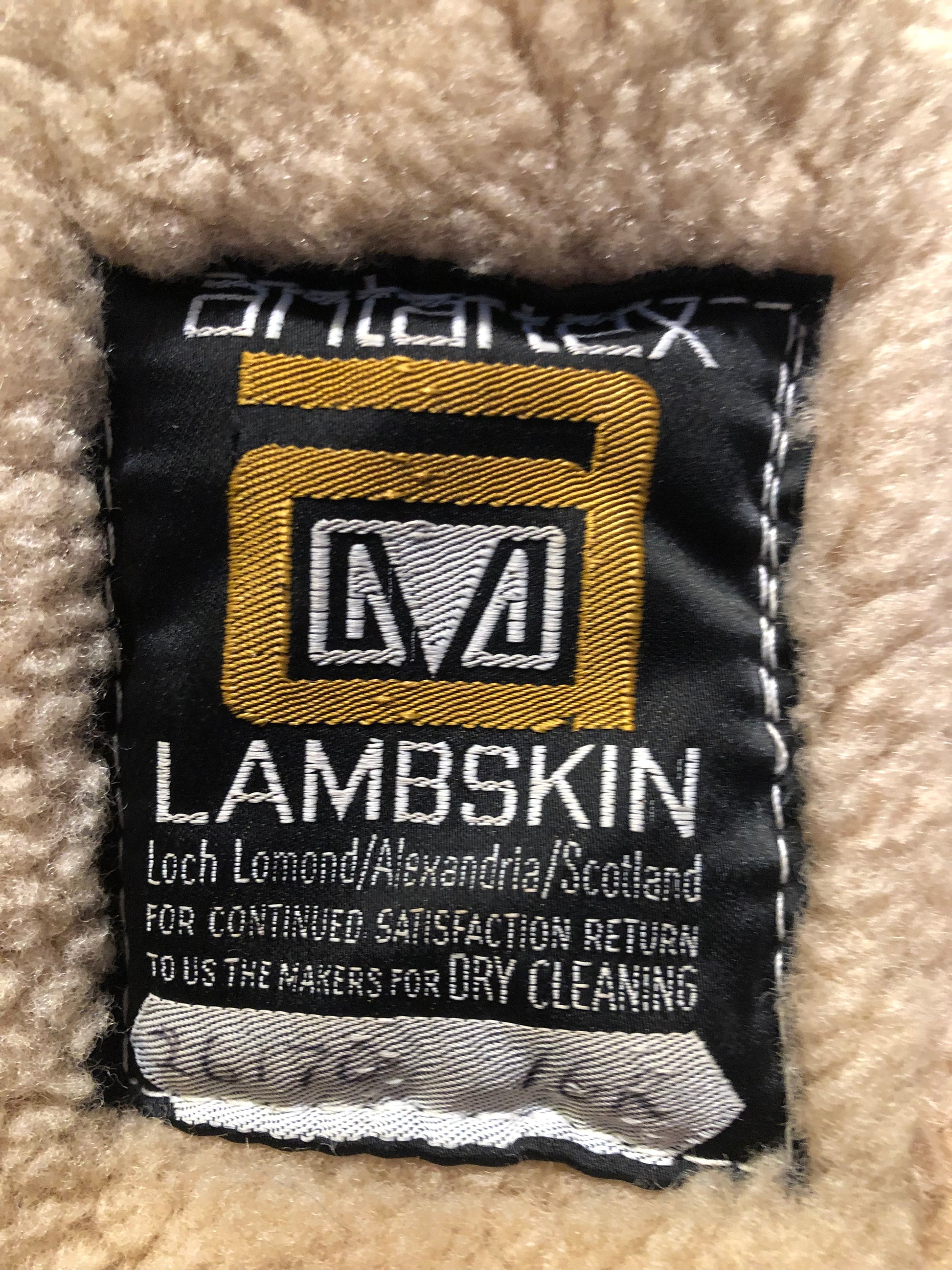 Vintage Antarrex Mongolian lambskin full length shearling coat with button closures and two front pockets.