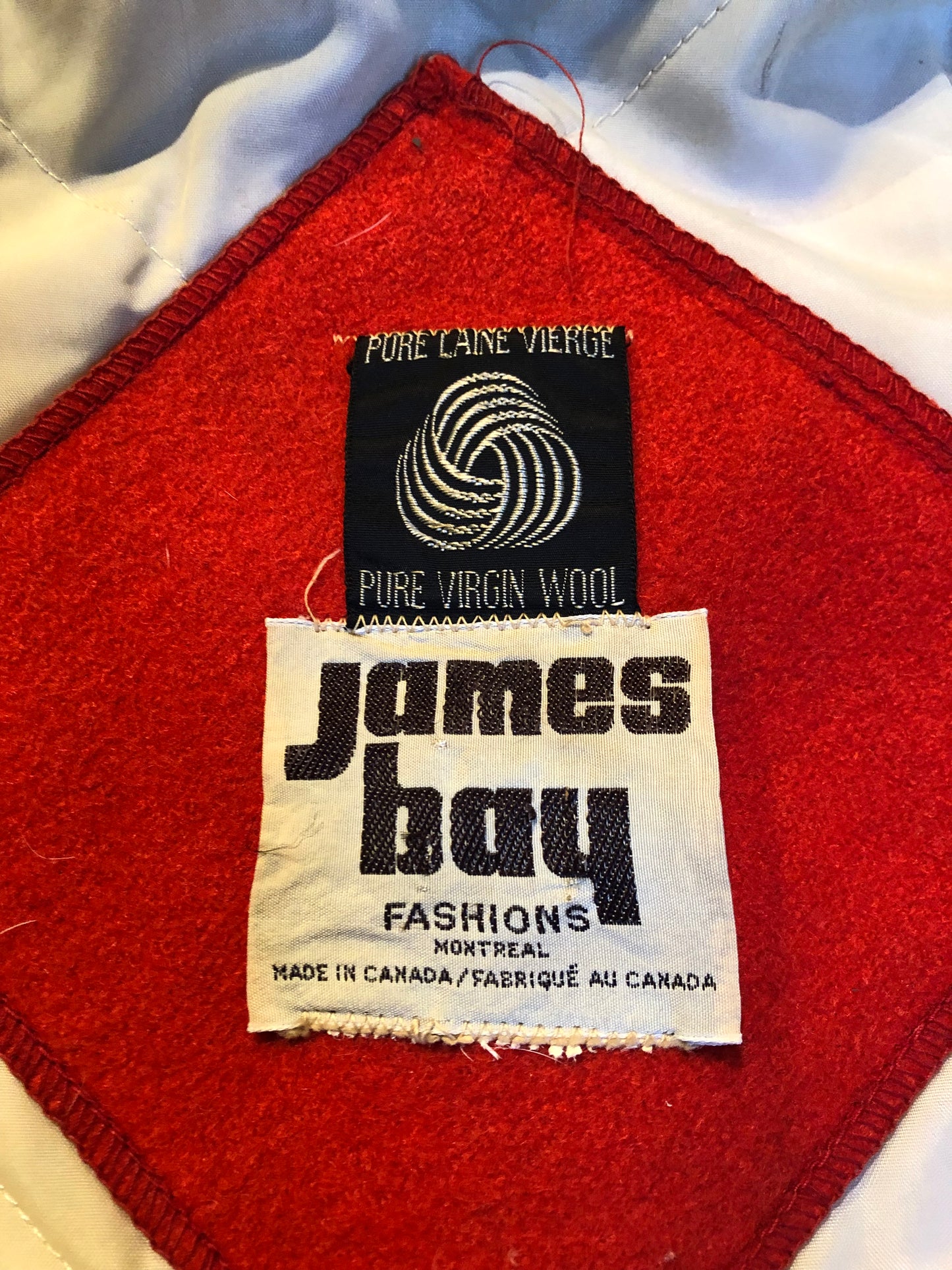 Kingspier Vintage - Vintage James Bay 100% virgin wool northern parka in bright red. This parka features a fur trimmed hood, zipper closure, pockets, quilted lining, storm cuffs, and penguin scene in felt applique. Made in Canada.