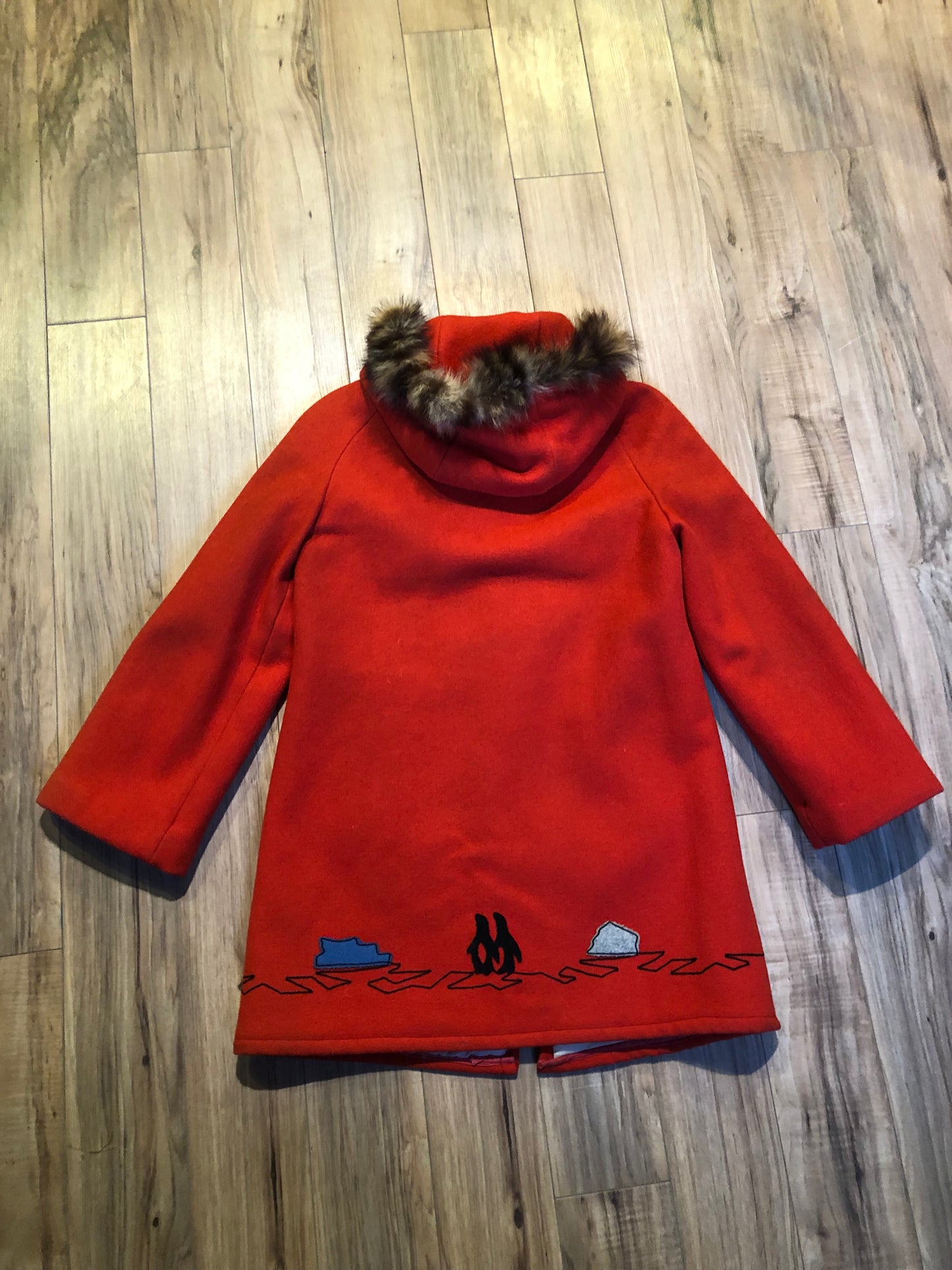 Kingspier Vintage - Vintage James Bay 100% virgin wool northern parka in bright red. This parka features a fur trimmed hood, zipper closure, pockets, quilted lining, storm cuffs, and penguin scene in felt applique. Made in Canada.