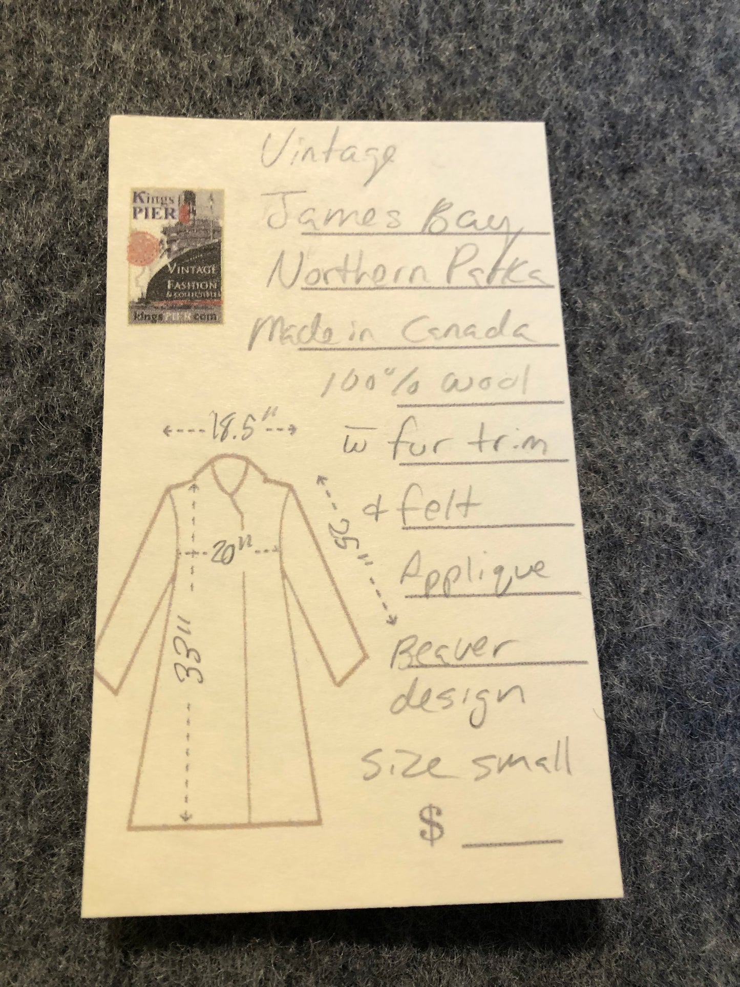 Kingspier Vintage - Vintage James Bay 100% virgin wool northern parka in grey. This parka features a fur trimmed hood, zipper closure, patch pockets, quilted lining, storm cuffs, leather trim, custom embroidery and a beaver design in felt applique.
Made in Canada.
Size small.