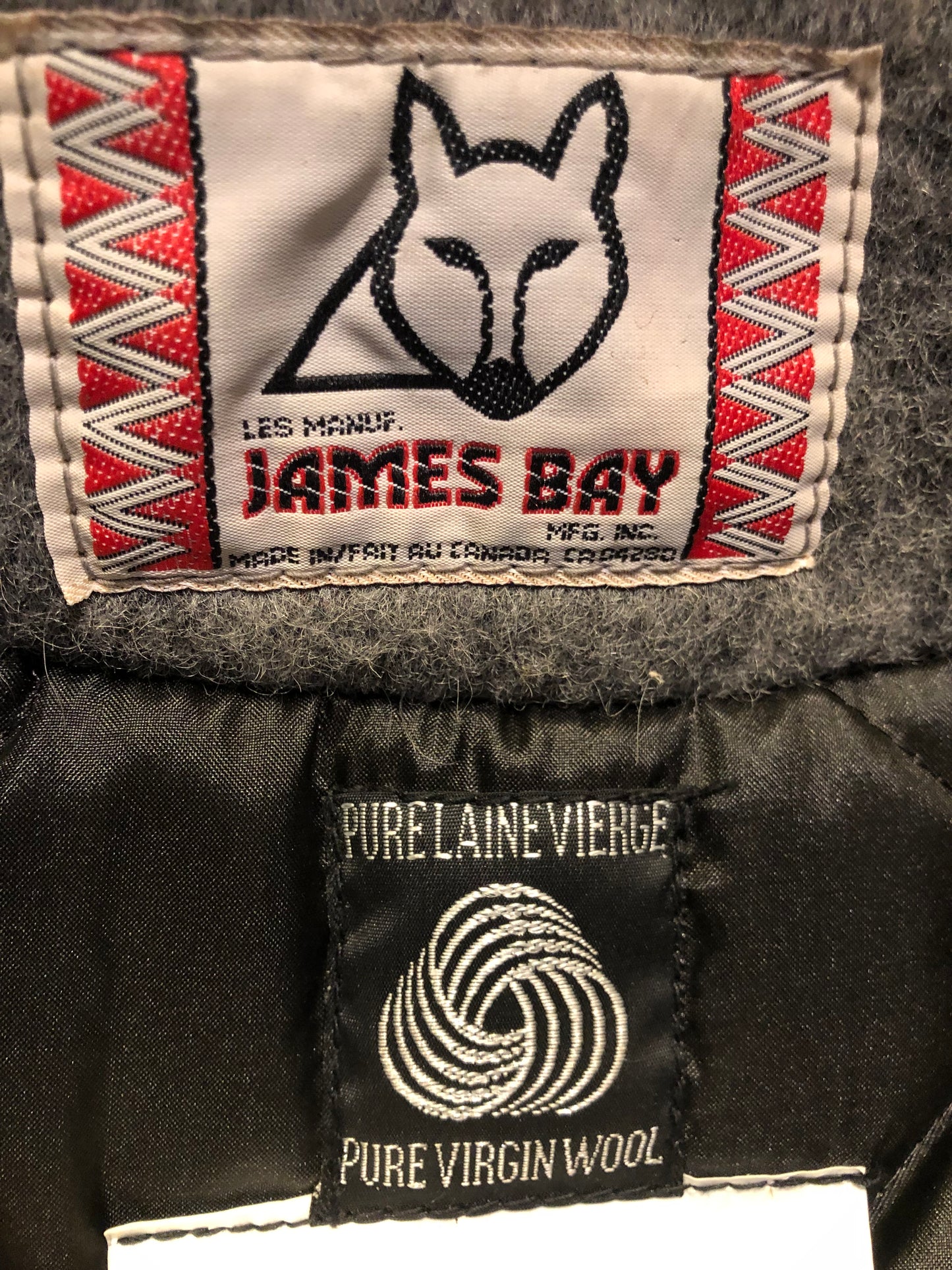 Kingspier Vintage - Vintage James Bay 100% virgin wool northern parka in grey. This parka features a fur trimmed hood, zipper closure, patch pockets, quilted lining, storm cuffs, leather trim, custom embroidery and a beaver design in felt applique.
Made in Canada.
Size small.