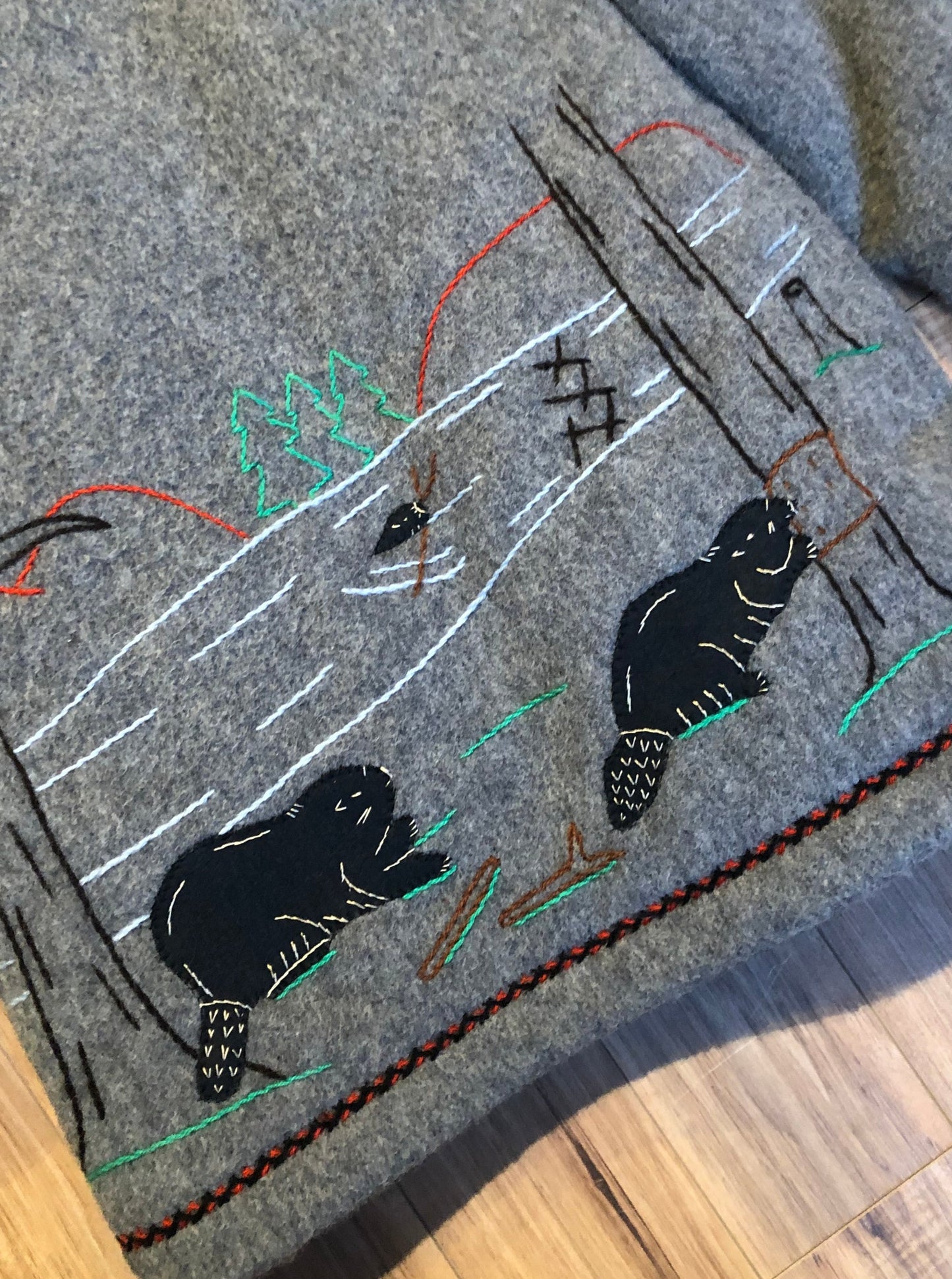 Kingspier Vintage - Vintage James Bay 100% virgin wool northern parka in grey. This parka features a fur trimmed hood, zipper closure, patch pockets, quilted lining, storm cuffs, leather trim, custom embroidery and a beaver design in felt applique.
Made in Canada.
Size small.