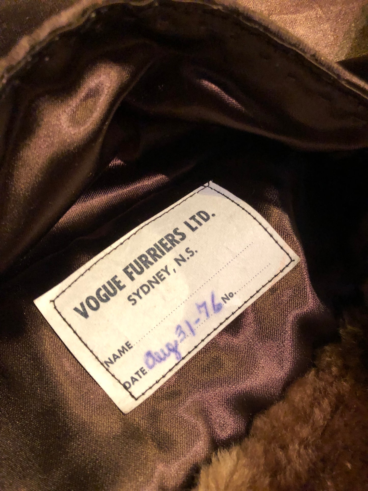 Kingspier Vintage - Vintage Vogue Furriers long fur coat circa 1970’s features leather button closures, two front pockets abd a brown satin lining.
Made in Nova Scotia, Canada.
Size Large.