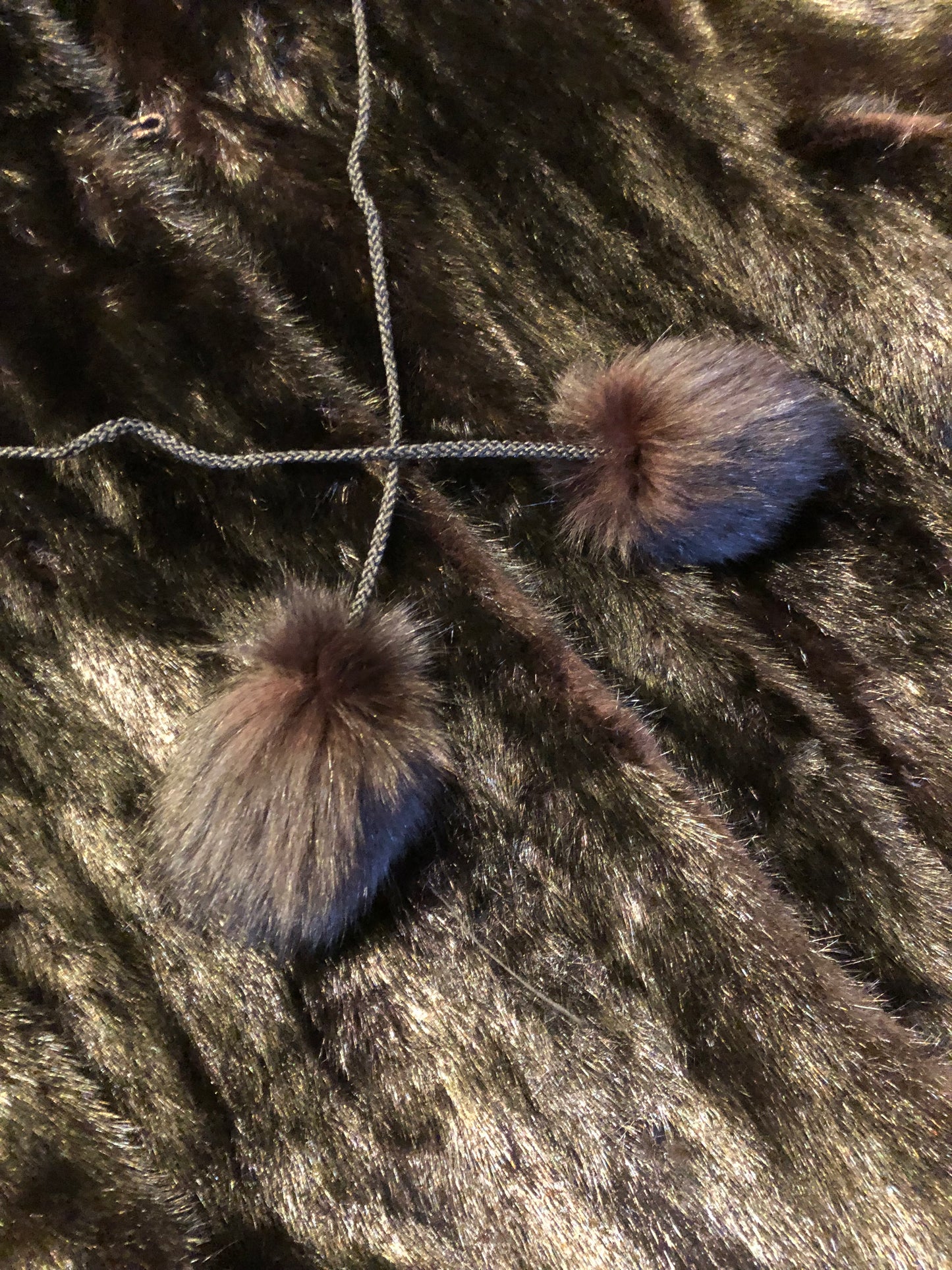 Kingspier Vintage - Vintage Furs by Offerman long fur coat with fur pom poms and a removable hood, hook and eye closures, pockets and an “M.R.M” monogram on the black satin lining.
Made in Nova Scotia, Canada.