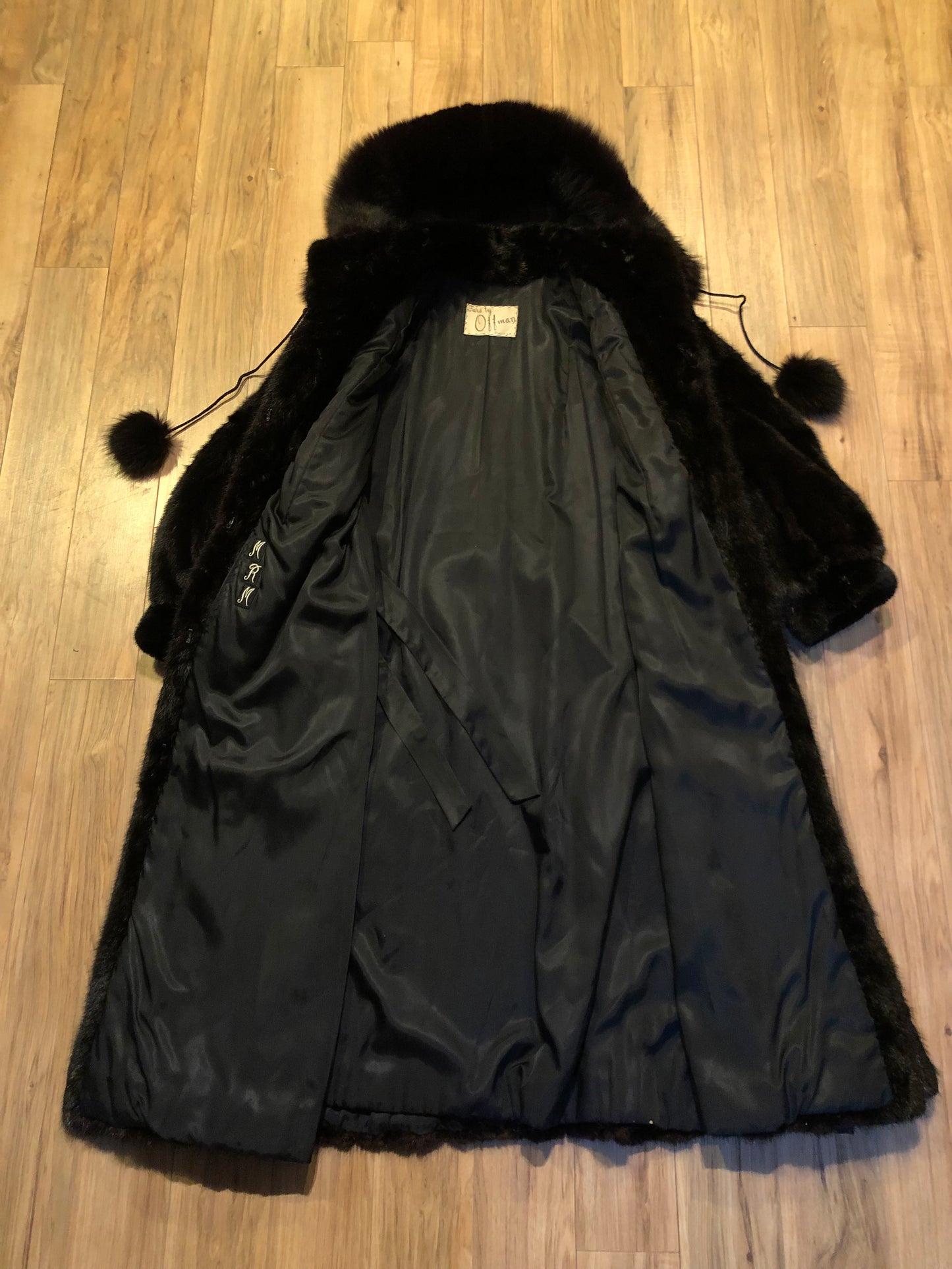 Kingspier Vintage - Vintage Furs by Offerman long fur coat with fur pom poms and a removable hood, hook and eye closures, pockets and an “M.R.M” monogram on the black satin lining.
Made in Nova Scotia, Canada.