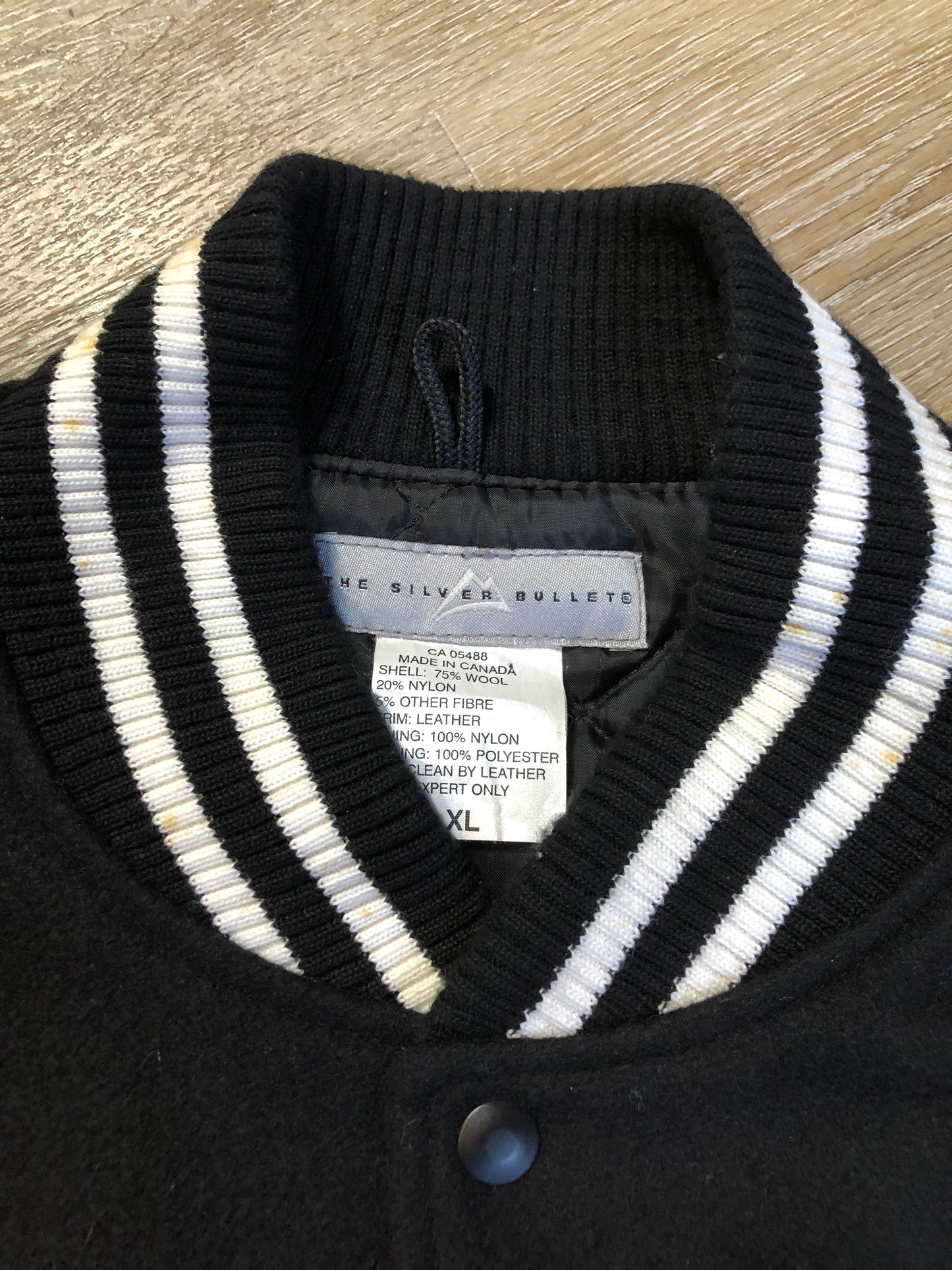 Kingspier Vintage - Coors Light black wool blend varsity jacket with black leather arms, knit trim, slash pockets, snap closure and a quilted lining. Men’s XL.