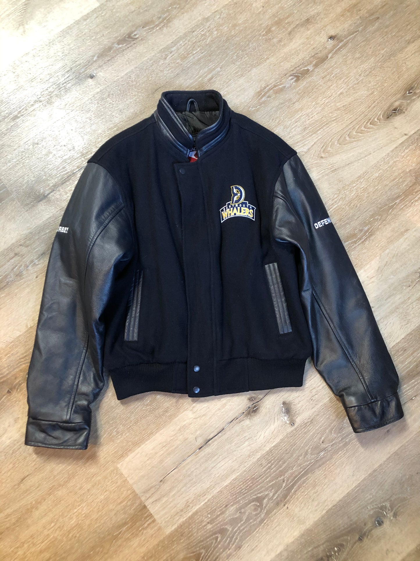 Kingspier Vintage - Dartmouth Whalers navy blue wool blend with leather trim varsity jacket. Jacket features Dartmouth whalers emblem on the chest and the back, “defence” embroidered on the left sleeve and “Forbes” embroidered on the right sleeve, insulated lining, two inside pockets, two slash pockets, zipper and snap closures. Made by Canada sportswear. Size small.