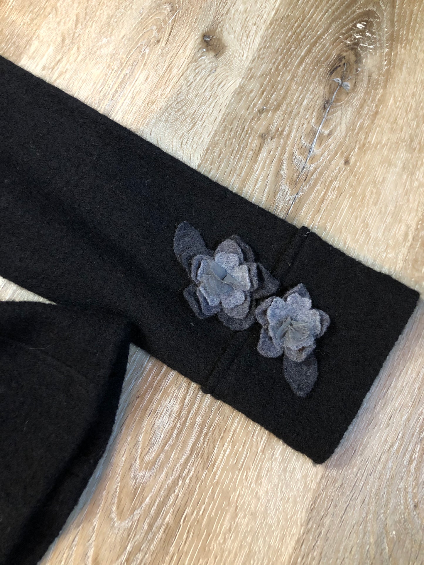 Kingspier Vintage - Cynthia Rowley black belted wool cardigan with buttons and grey wool flower details. Size medium.