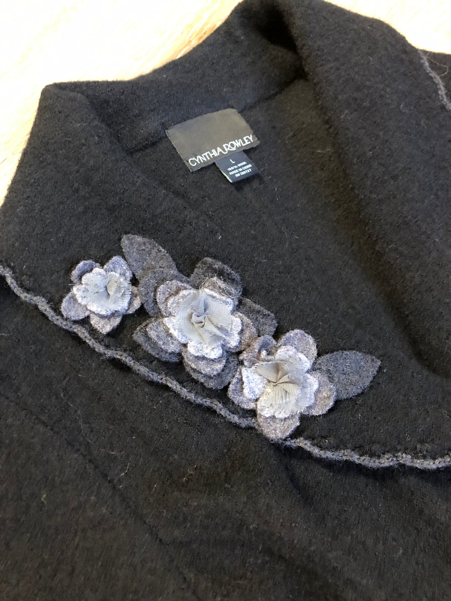 Kingspier Vintage - Cynthia Rowley black belted wool cardigan with buttons and grey wool flower details. Size medium.