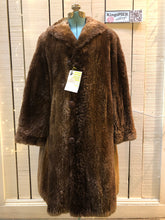 Load image into Gallery viewer, Kingspier Vintage - Vintage Vogue Furriers long fur coat circa 1970’s features leather button closures, two front pockets abd a brown satin lining.Made in Nova Scotia, Canada.Size Large.
