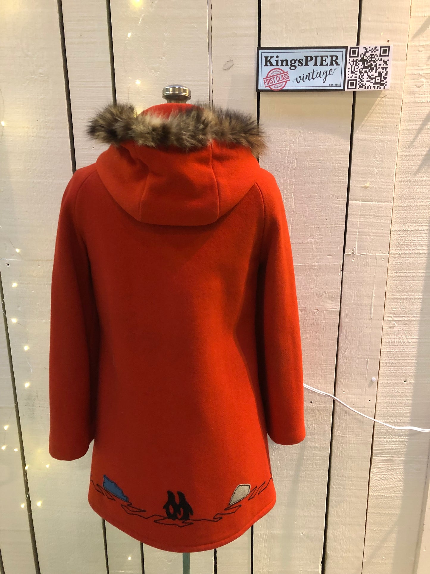 Kingspier Vintage - Vintage James Bay 100% virgin wool northern parka in bright red. This parka features a fur trimmed hood, zipper closure, pockets, quilted lining, storm cuffs, and penguin scene in felt applique. Made in Canada.