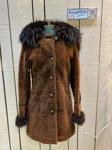 Kingspier Vintage - Vintage Weitral shearling coat with fur trimmed hood and cuffs, unique button closures, leather details with floral motif and two front pockets.

Size large.
Made in Russia.