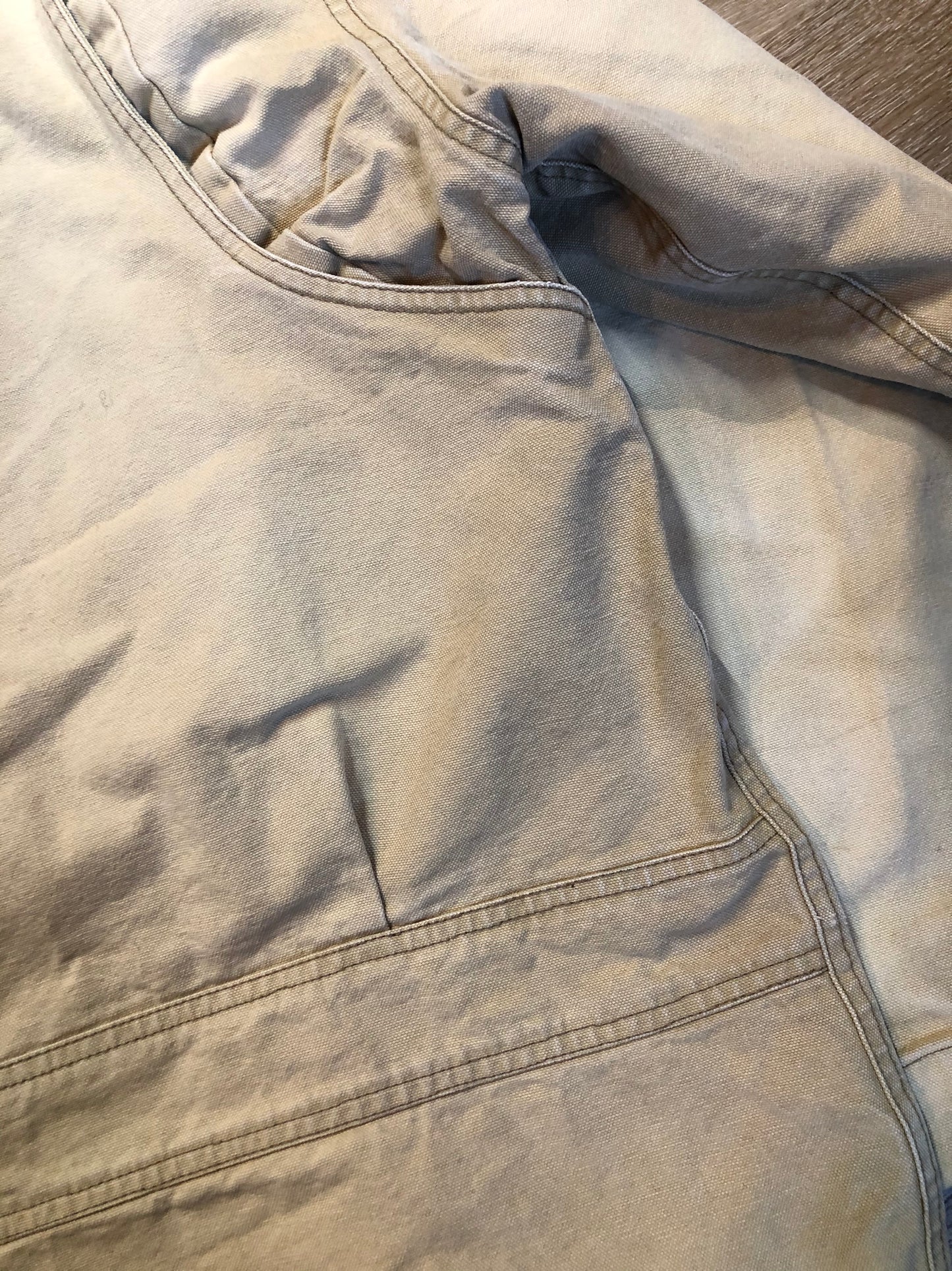 Kingspier Vintage - Woolrich beige chore jacket with cotton shell, leather collar, wool blend lining, snap closures and two flap pockets. Size XL.