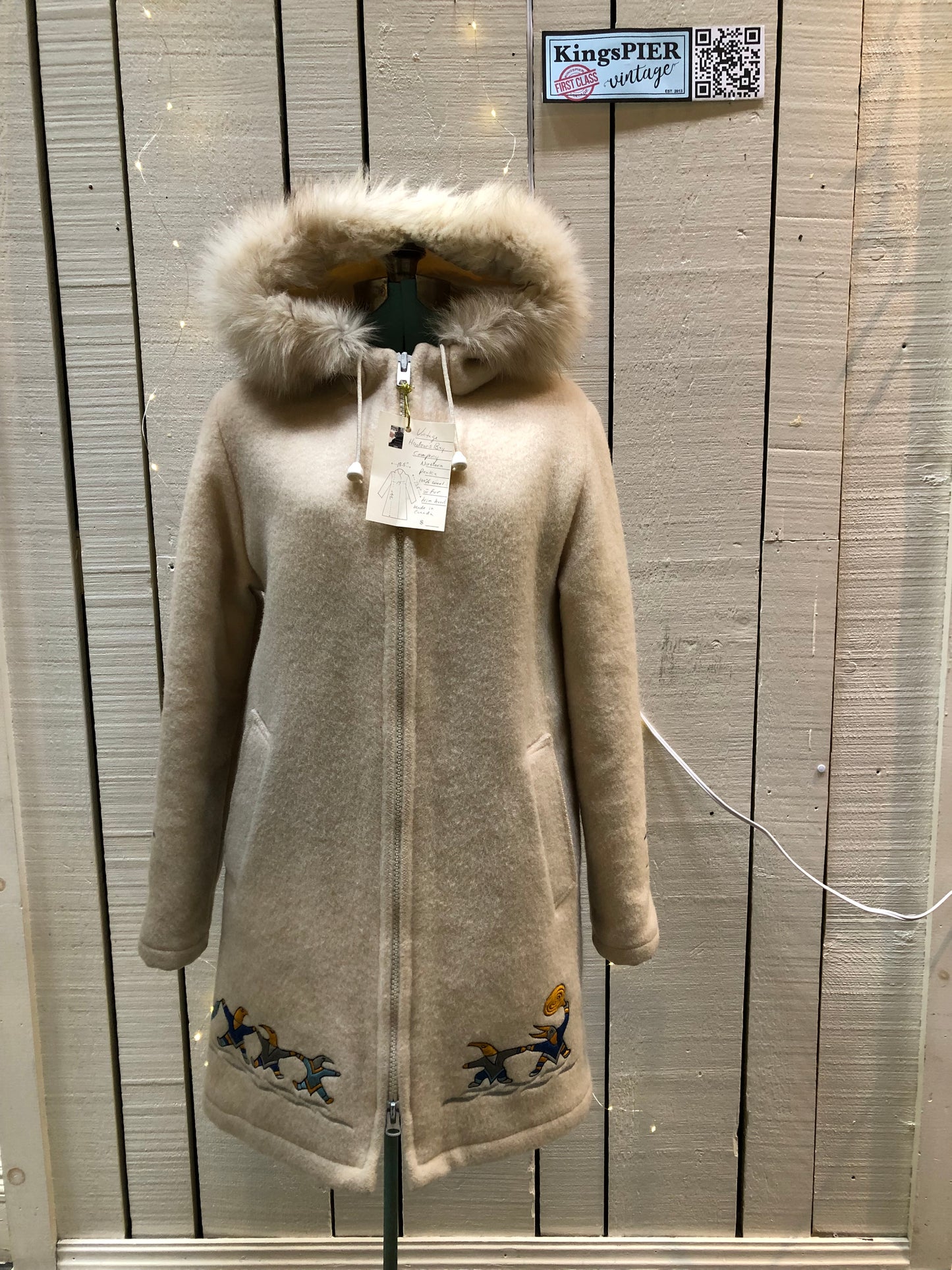 Kingspier Vintage - Vintage Hudson’s Bay Company white wool parka with embroidered northern indigenous design, fur trimmed hood, zipper closure, quilted lining and two front pockets.
Made in Canada.