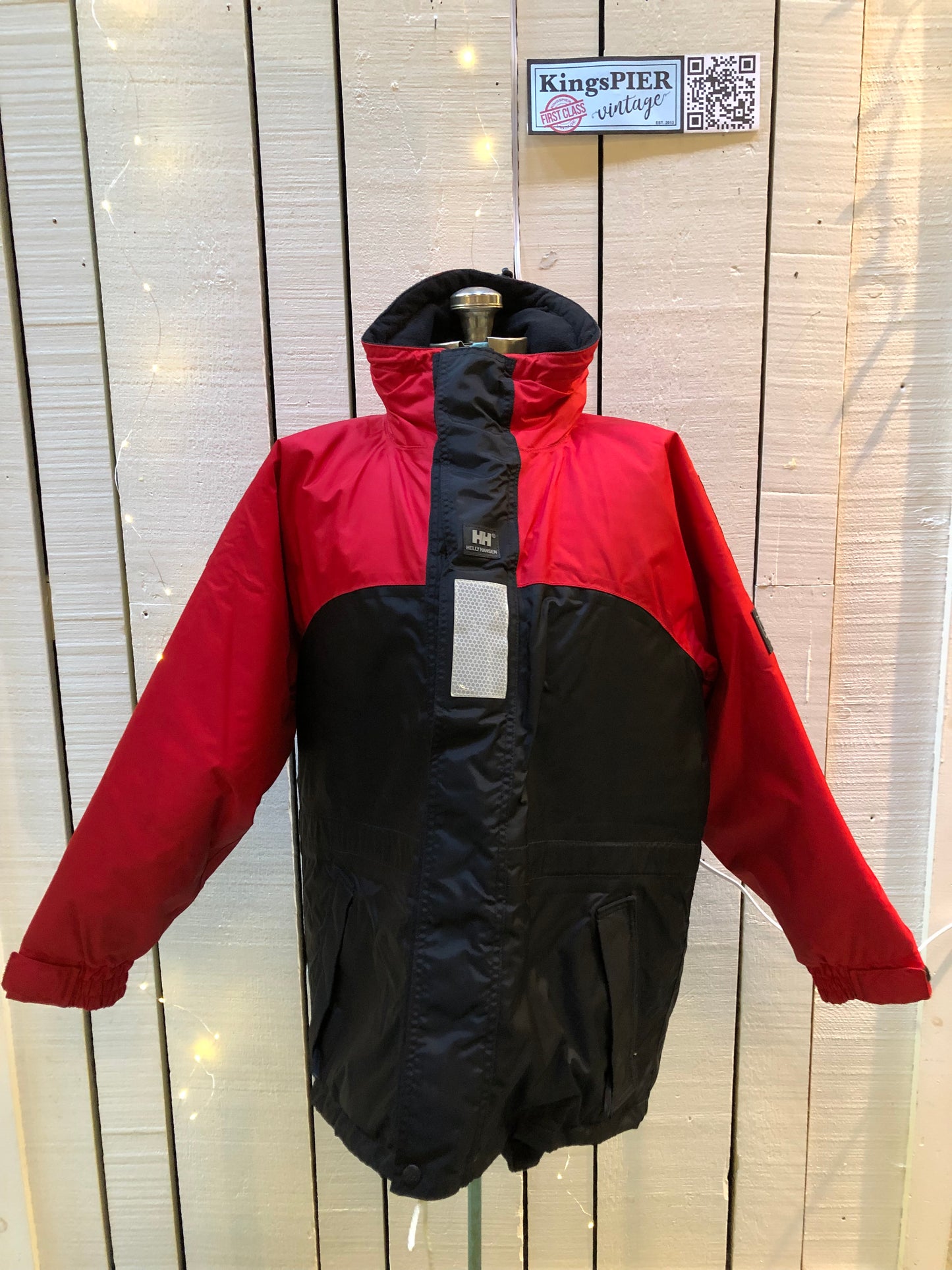 Kingspier Vintage - Helly Hansen red and black Soft Flex Echo Parka with Personal Flotation Device, Canadian Coast Guard approved.
Jacket features a packable hood, adjustable storm collar, zipper and snap closures, zip front pockets, waterproof shell, and PVC foam buoyant component.
Size Small.