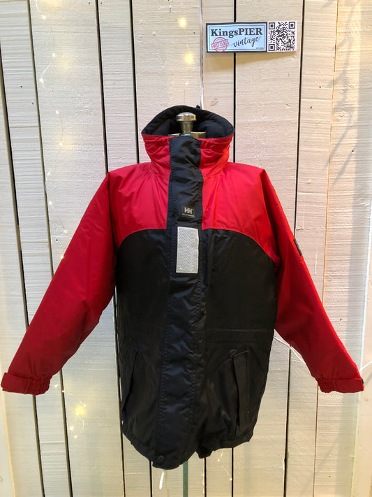 Kingspier Vintage - Helly Hansen red and black Soft Flex Echo Parka with Personal Flotation Device, Canadian Coast Guard approved.
Jacket features a packable hood, adjustable storm collar, zipper and snap closures, zip front pockets, waterproof shell, and PVC foam buoyant component.
Size Small.