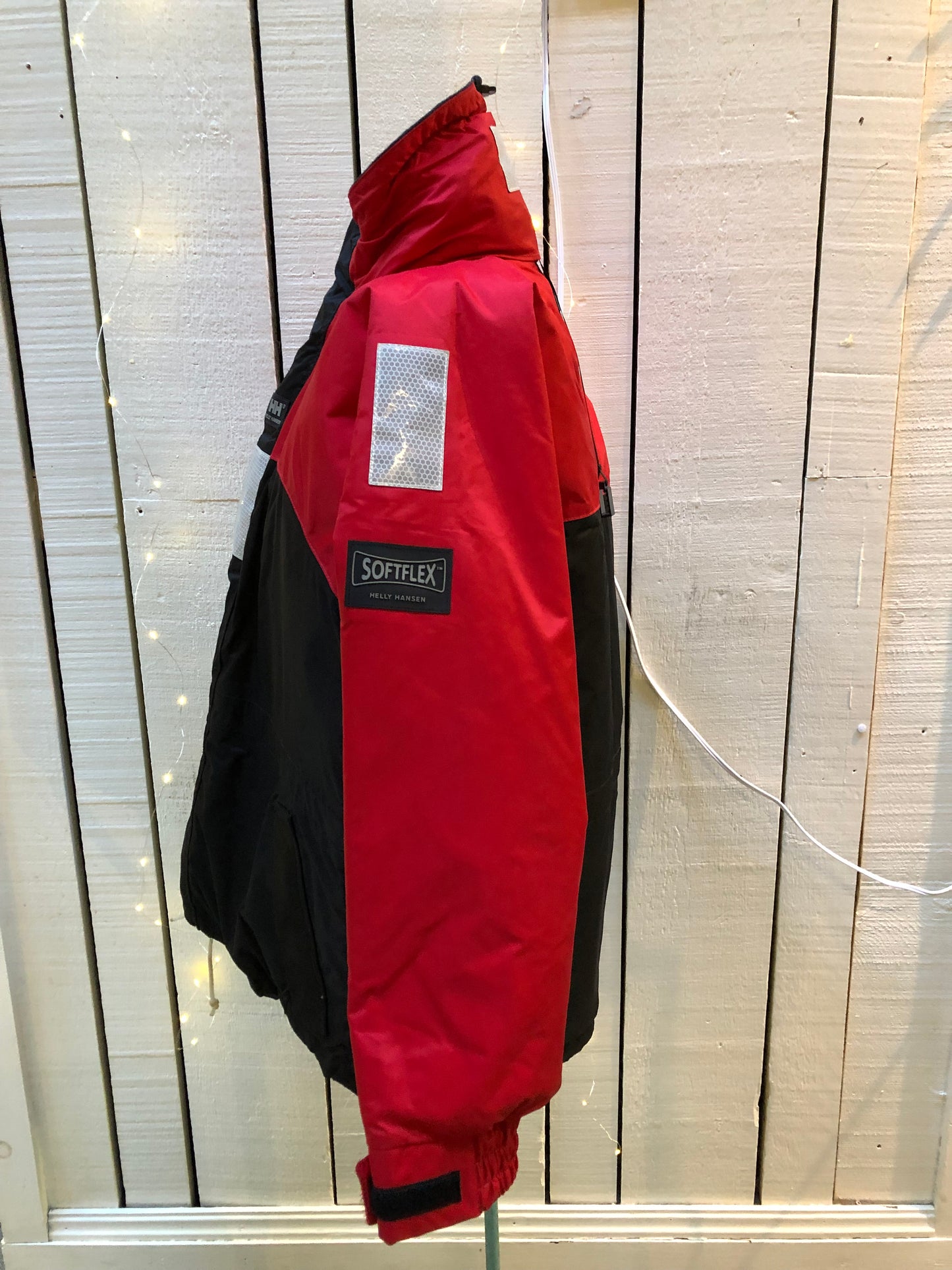 Kingspier Vintage - Helly Hansen red and black Soft Flex Echo Parka with Personal Flotation Device, Canadian Coast Guard approved.
Jacket features a packable hood, adjustable storm collar, zipper and snap closures, zip front pockets, waterproof shell, and PVC foam buoyant component.
Size Small.