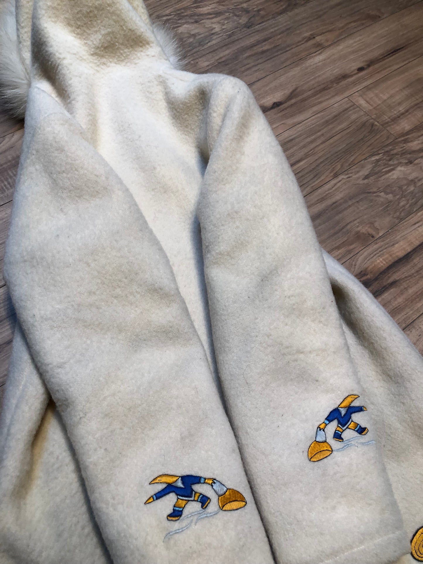 Kingspier Vintage - Vintage Hudson’s Bay Company white wool parka with embroidered northern indigenous design, fur trimmed hood, zipper closure, quilted lining and two front pockets.
Made in Canada.