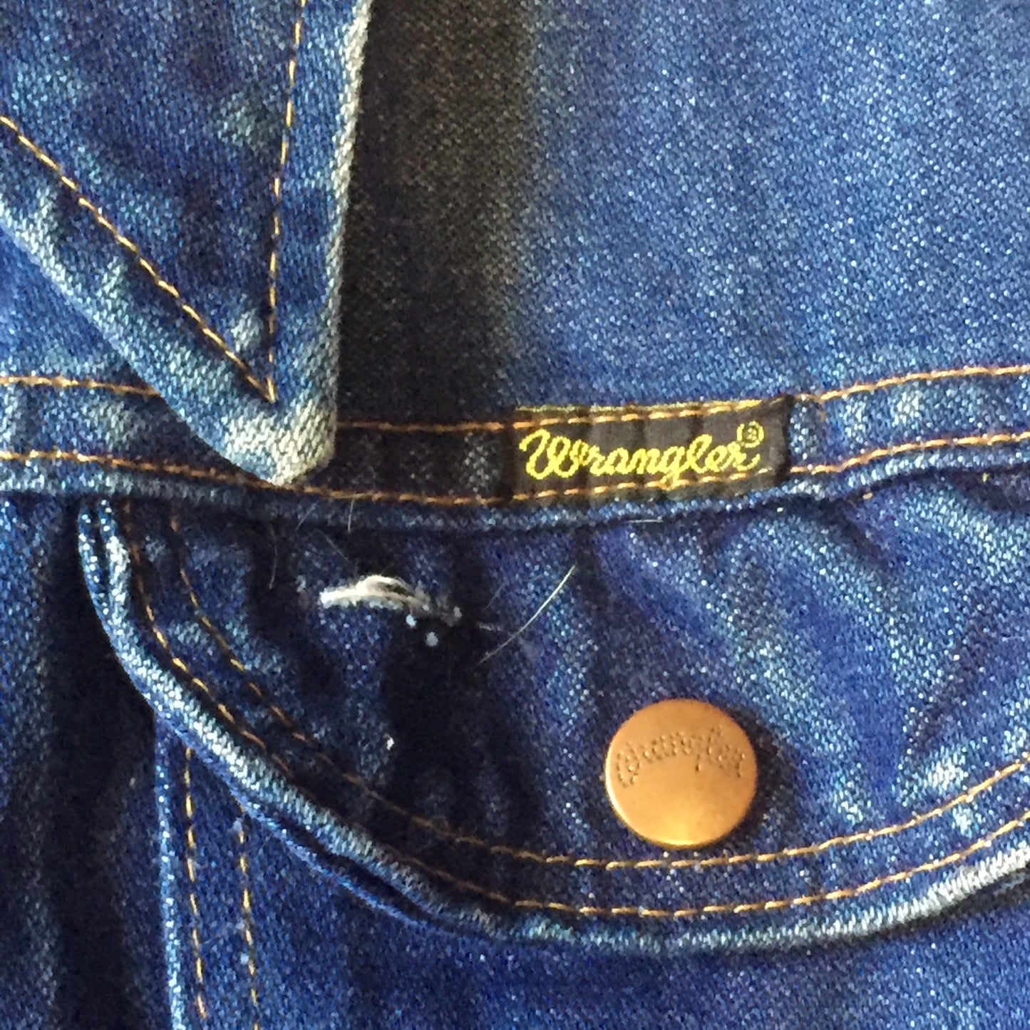 Kingspier Vintage - Vintage Wrangler medium wash denim jacket with iconic wrangler stitching, button closures, flap pockets on the chest and hand warmer pockets. Size medium. Made in USA.