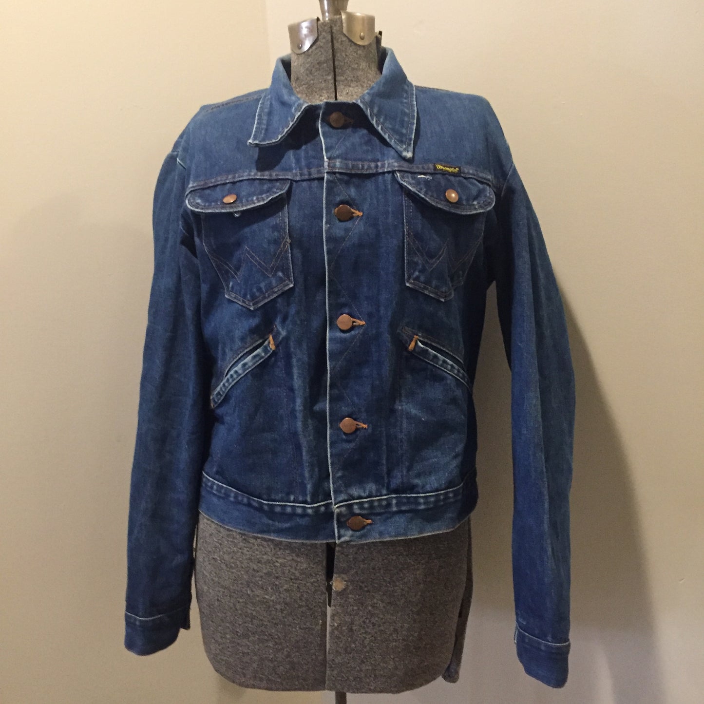 Kingspier Vintage - Vintage Wrangler medium wash denim jacket with iconic wrangler stitching, button closures, flap pockets on the chest and hand warmer pockets. Size medium. Made in USA.