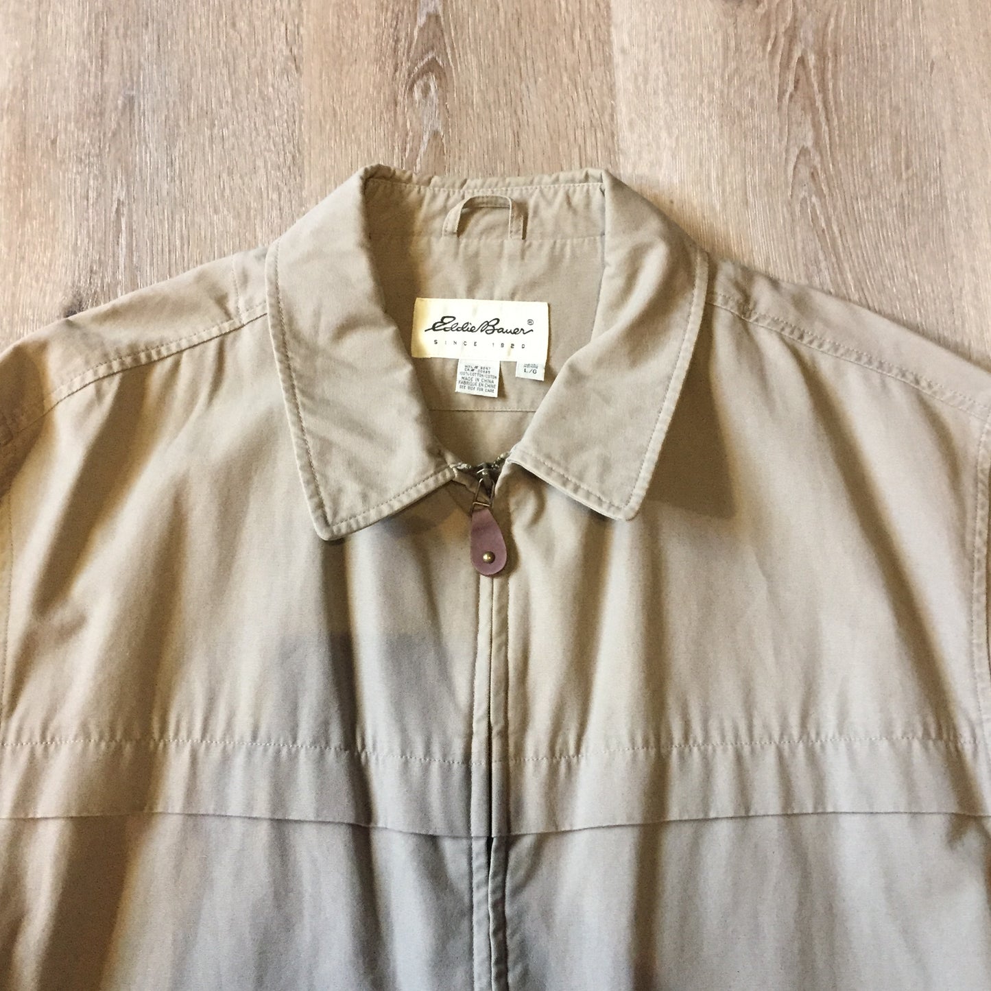 Kingspier Vintage - Eddie Bauer beige 100% cotton chore jacket with zipper closure and two flap pockets. Size large.