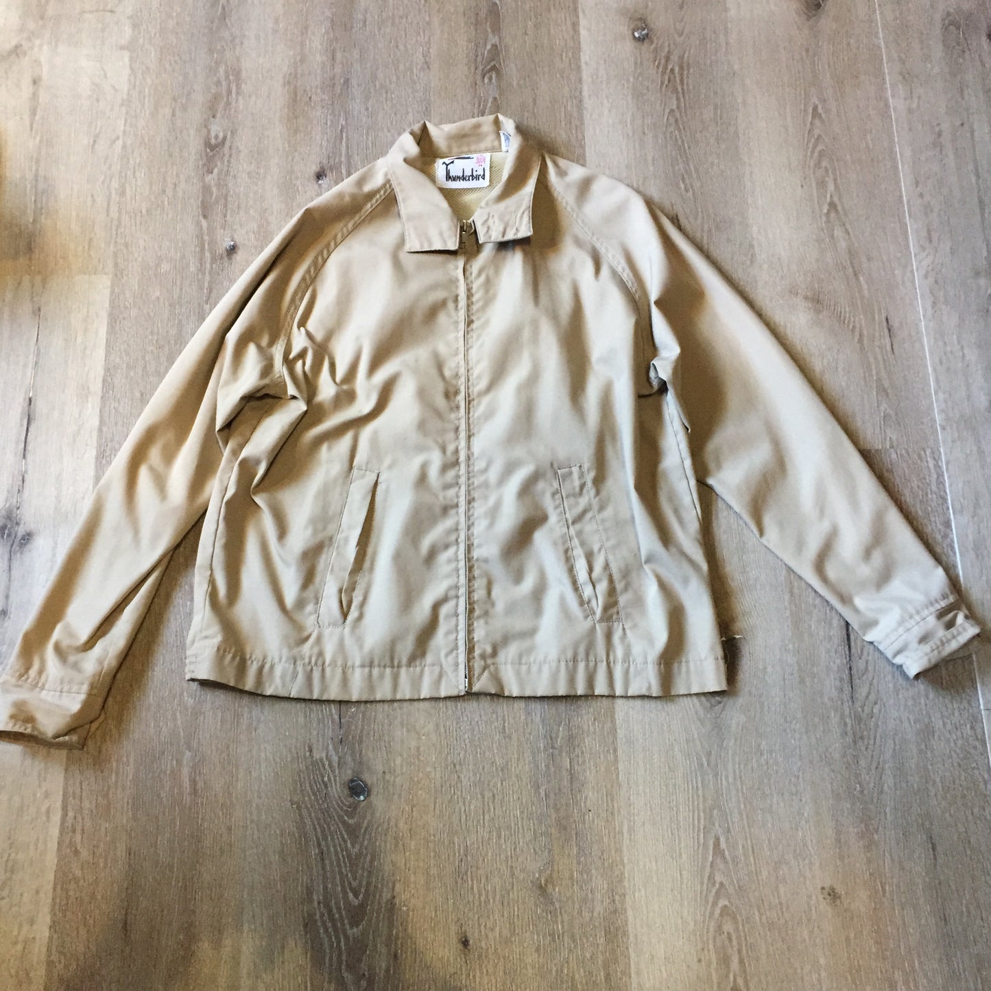 Kingspier Vintage - Vintage Thunderbird beige lightweight cotton/ poly blend jacket with zipper closure, slash pockets and nylon. Made in Korea. Size medium.
