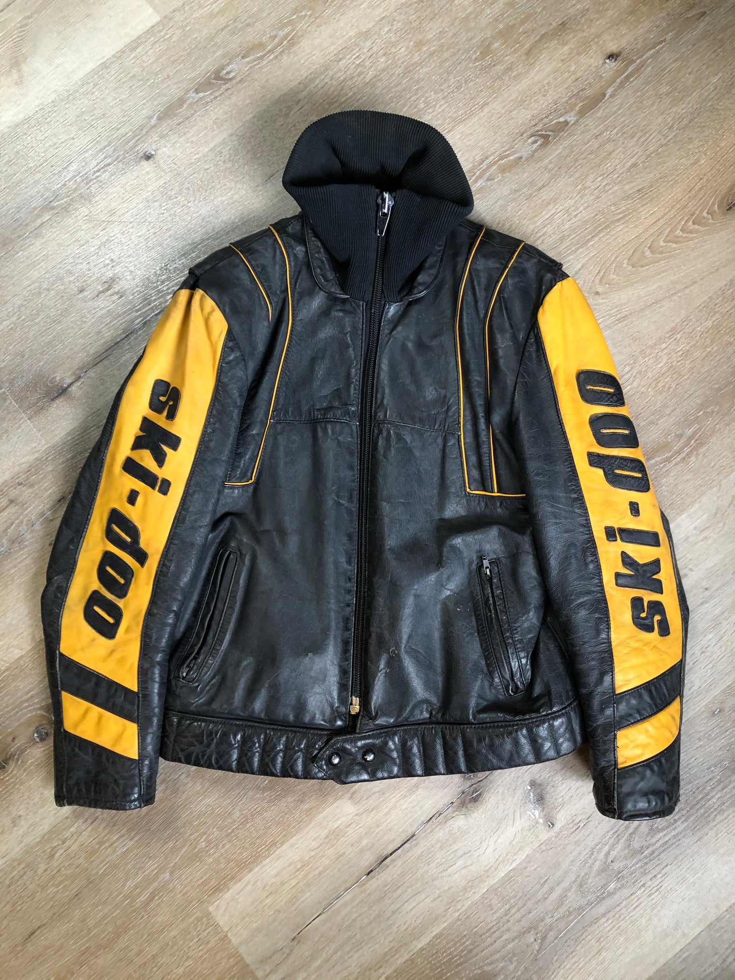Kingspier Vintage - Bombardier Ski-Doo black and yellow leather jacket by Drospo with knit collar, zipper closure, zip pockets, quilted lining and one inside zip pocket. Made in Canada