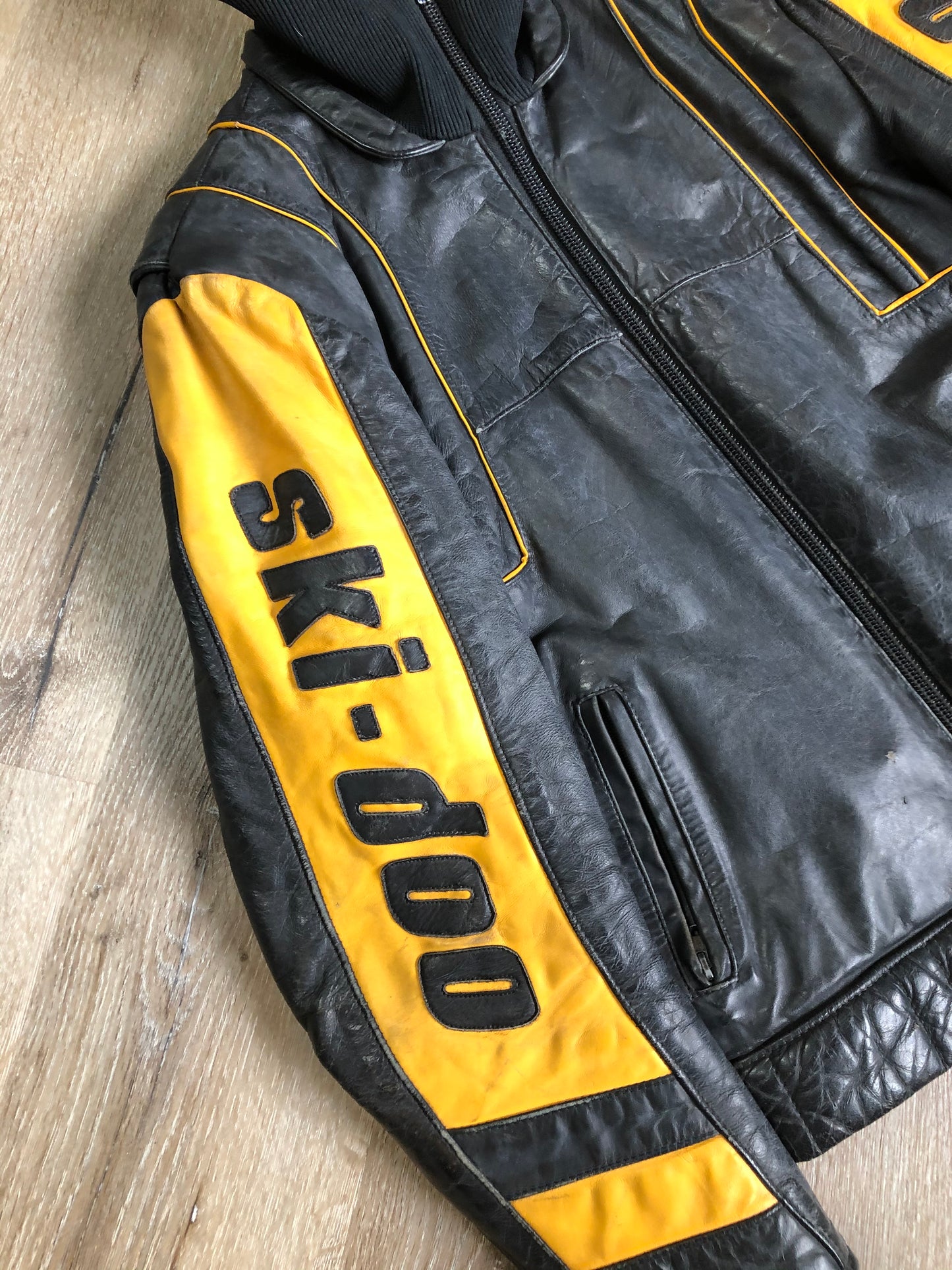 Kingspier Vintage - Bombardier Ski-Doo black and yellow leather jacket by Drospo with knit collar, zipper closure, zip pockets, quilted lining and one inside zip pocket. Made in Canada