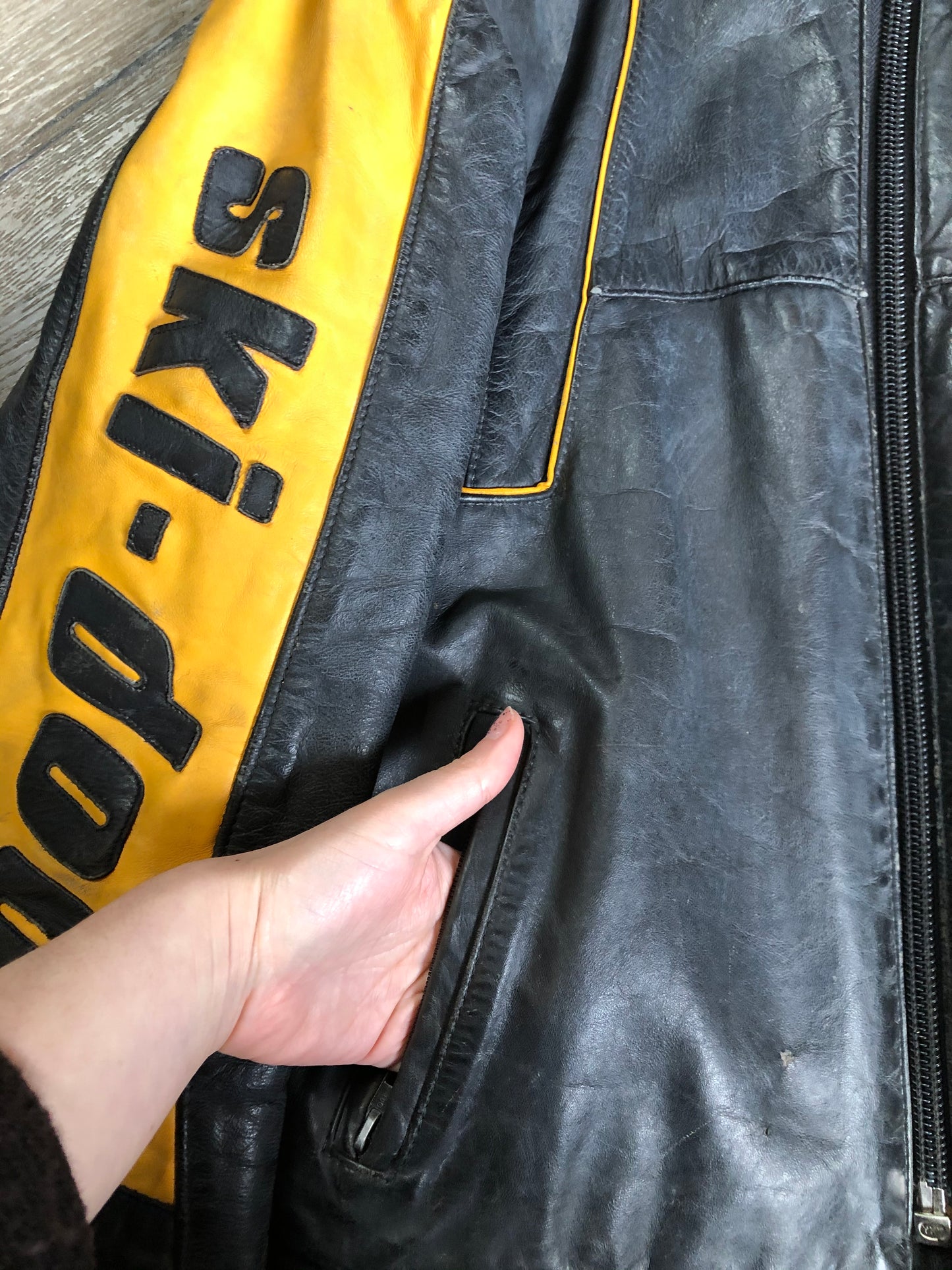 Kingspier Vintage - Bombardier Ski-Doo black and yellow leather jacket by Drospo with knit collar, zipper closure, zip pockets, quilted lining and one inside zip pocket. Made in Canada