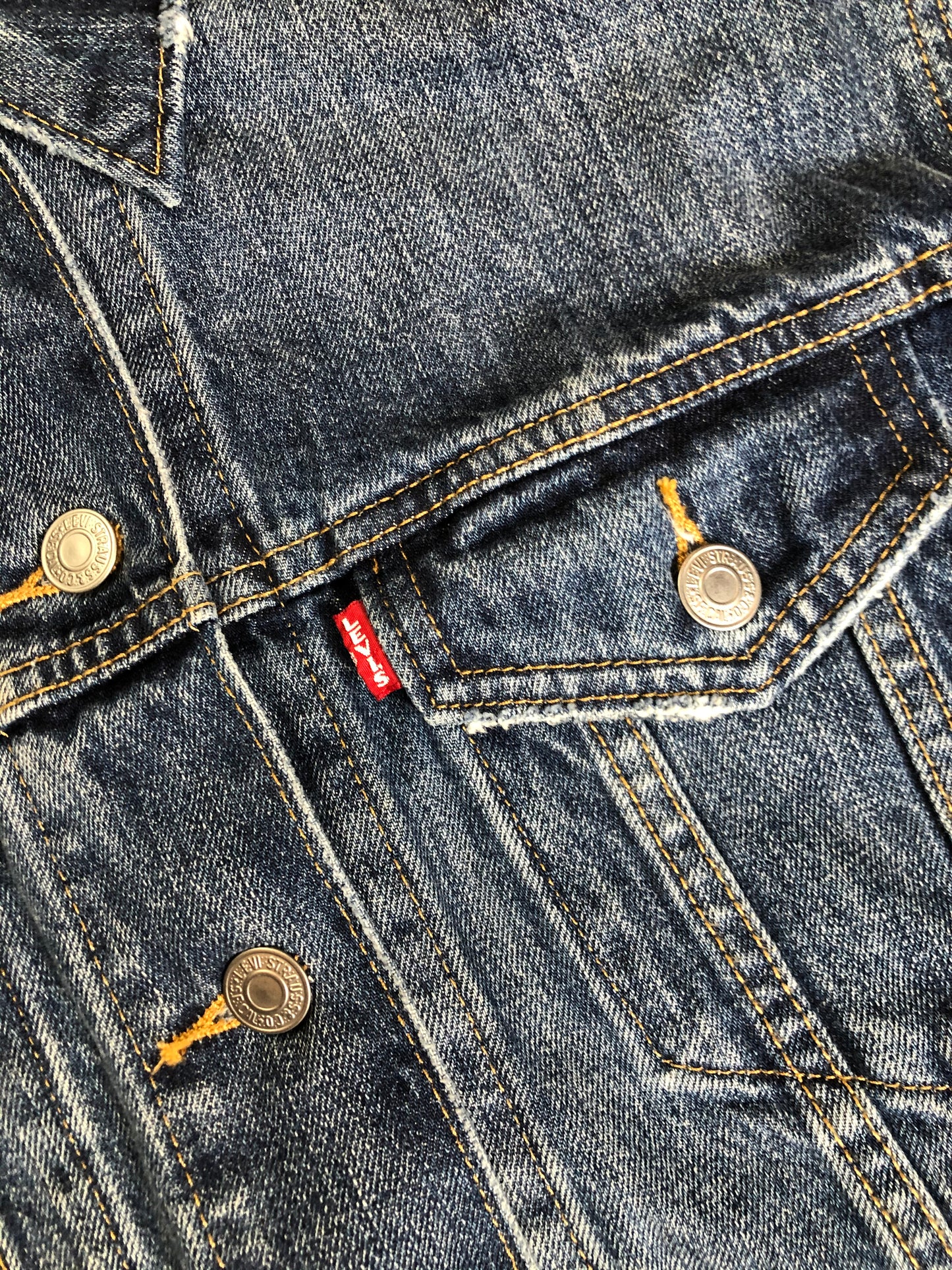 Kingspier Vintage - Levi’s Premium medium wash denim trucker jacket with button closures, two flap pockets on the chest and two slash pockets. Size medium.