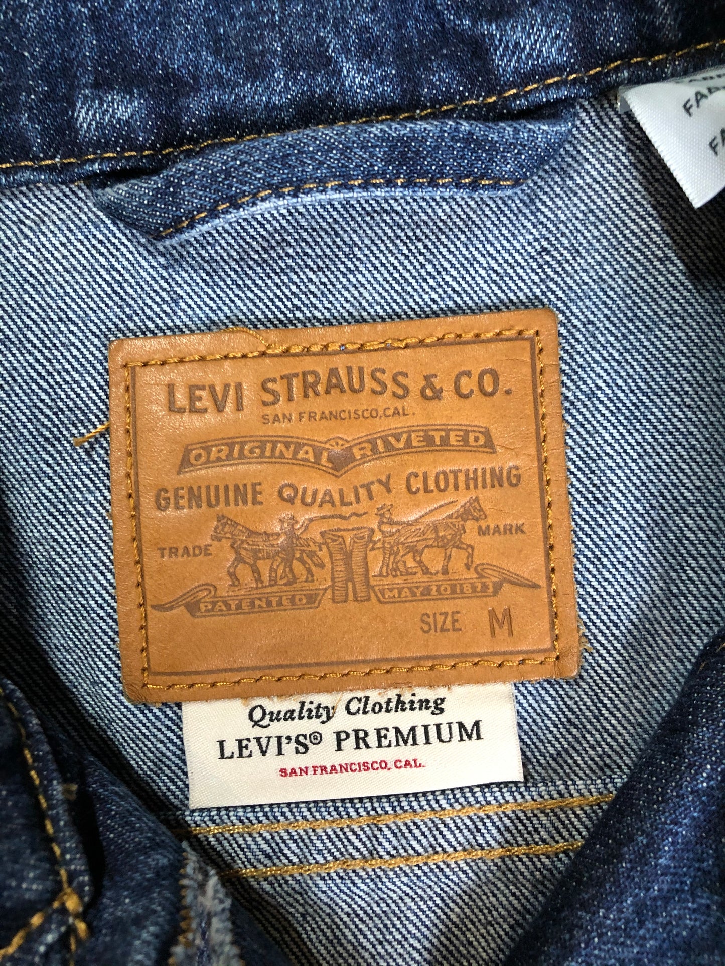 Kingspier Vintage - Levi’s Premium medium wash denim trucker jacket with button closures, two flap pockets on the chest and two slash pockets. Size medium.