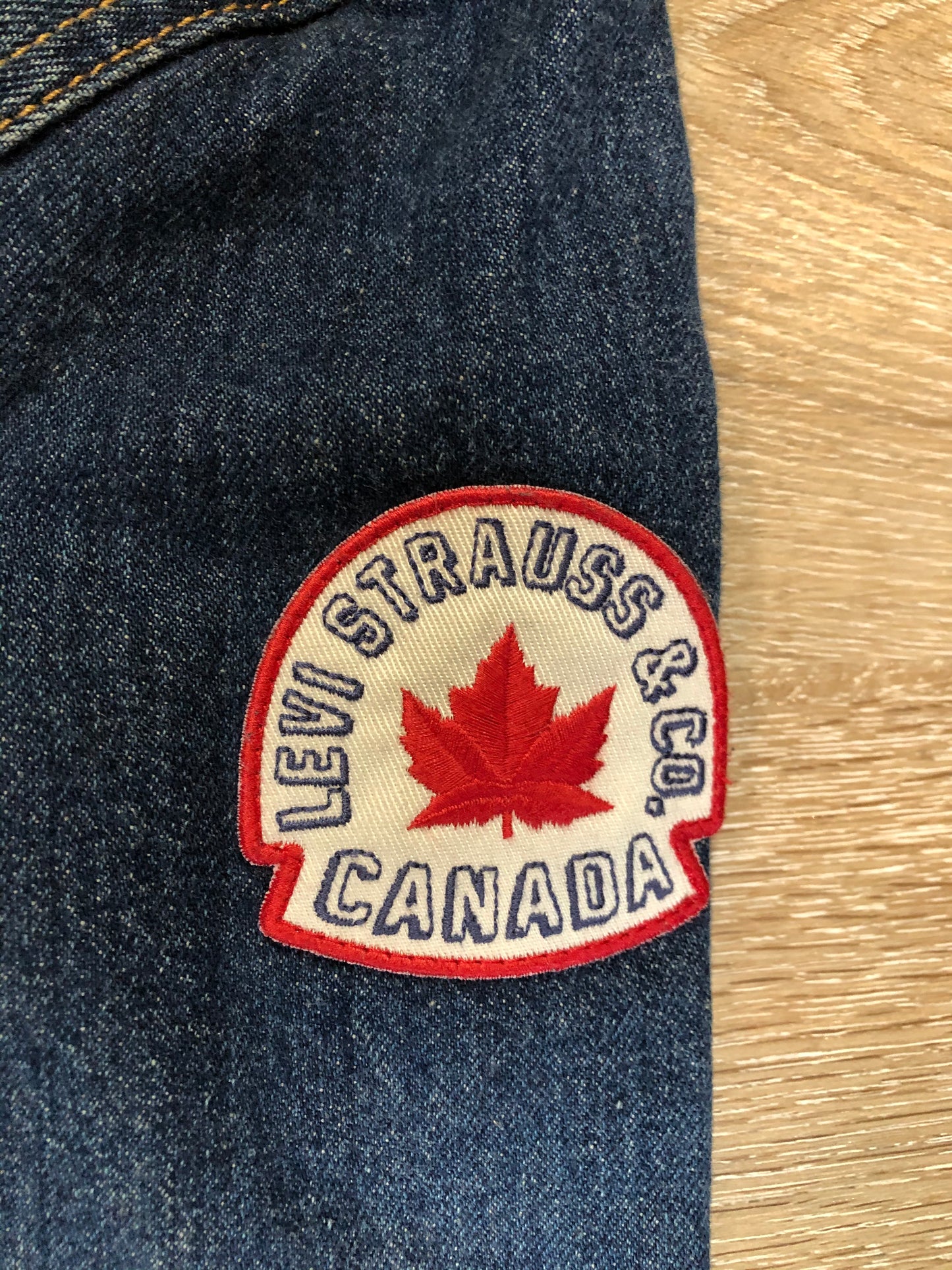 Kingspier Vintage - Levi’s medium wash denim trucker jacket with Levi’s Strauss and Co Canada patch on the arm. Size large.