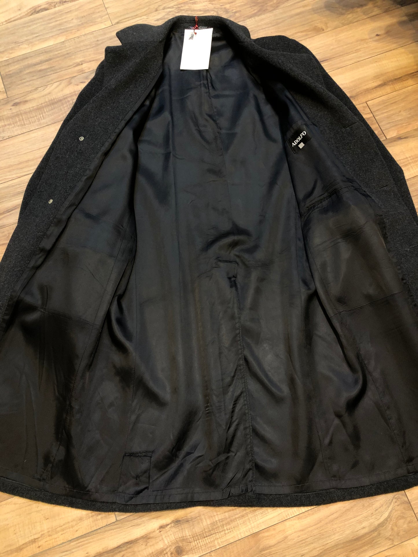Kingspier Vintage - Vintage Adolfo 100% wool coat in charcoal grey, button closures and front flap pockets.
Size 42 Long.
Made in USA.