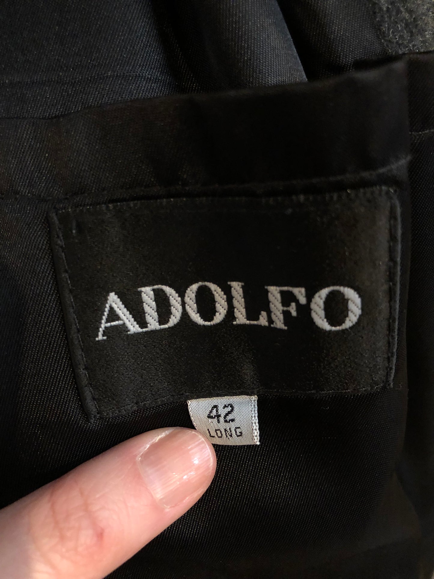 Kingspier Vintage - Vintage Adolfo 100% wool coat in charcoal grey, button closures and front flap pockets.
Size 42 Long.
Made in USA.