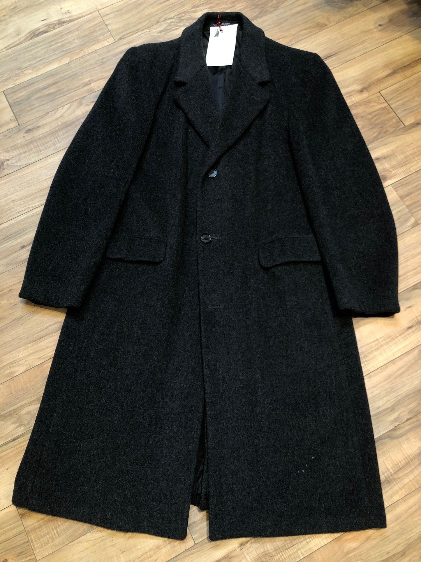 Kingspier Vintage - Vintage Adolfo 100% wool coat in charcoal grey, button closures and front flap pockets.
Size 42 Long.
Made in USA.