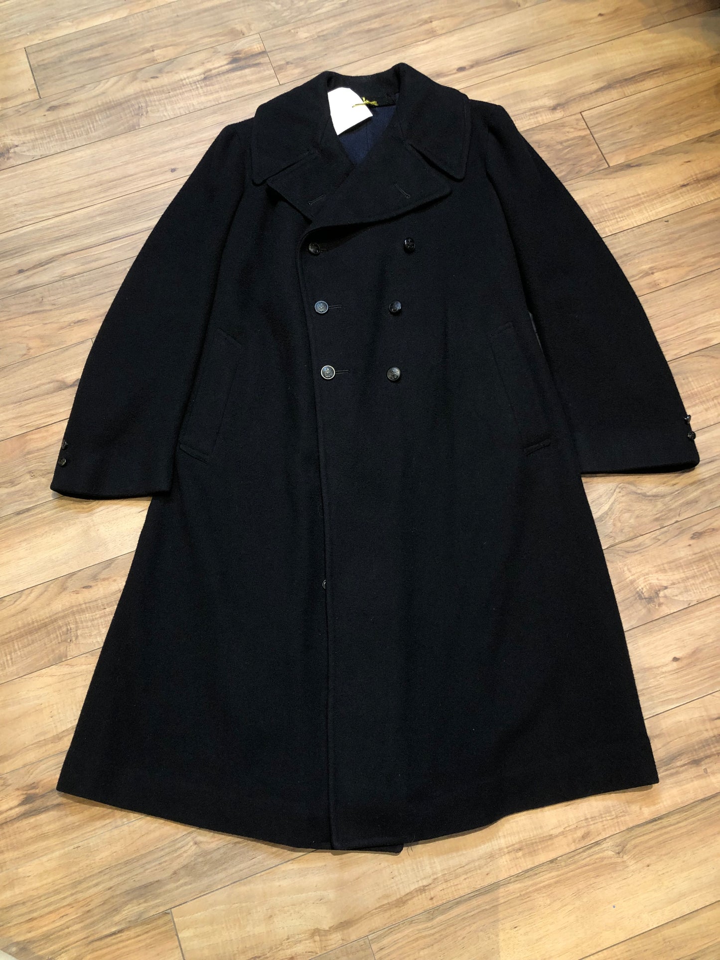 Kingspier Vintage - Rare Vintage 1940’s Bolter Bros Royal Canadian Sea Cadets double breasted long black wool coat. This coat features button closures, partial lining, two front pockets and two inside pockets.
Size 2/ 5ft 8
Made in Canada.