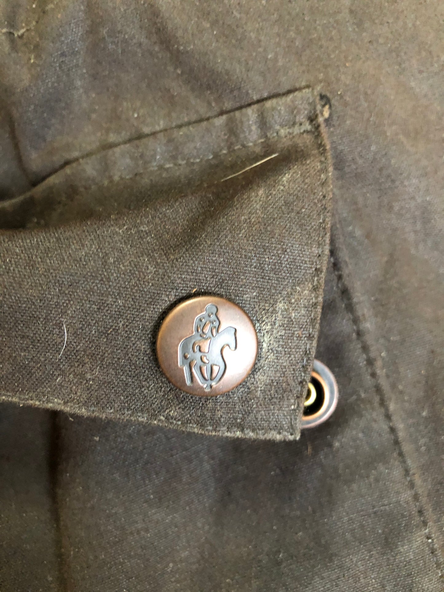 Kingspier Vintage - Outback Trading Co brown cotton oilskin rancher jacket with double snap closures, two snap flap pockets, one inside zip pocket, lightweight lining and drawstring at the waist. Fits large.