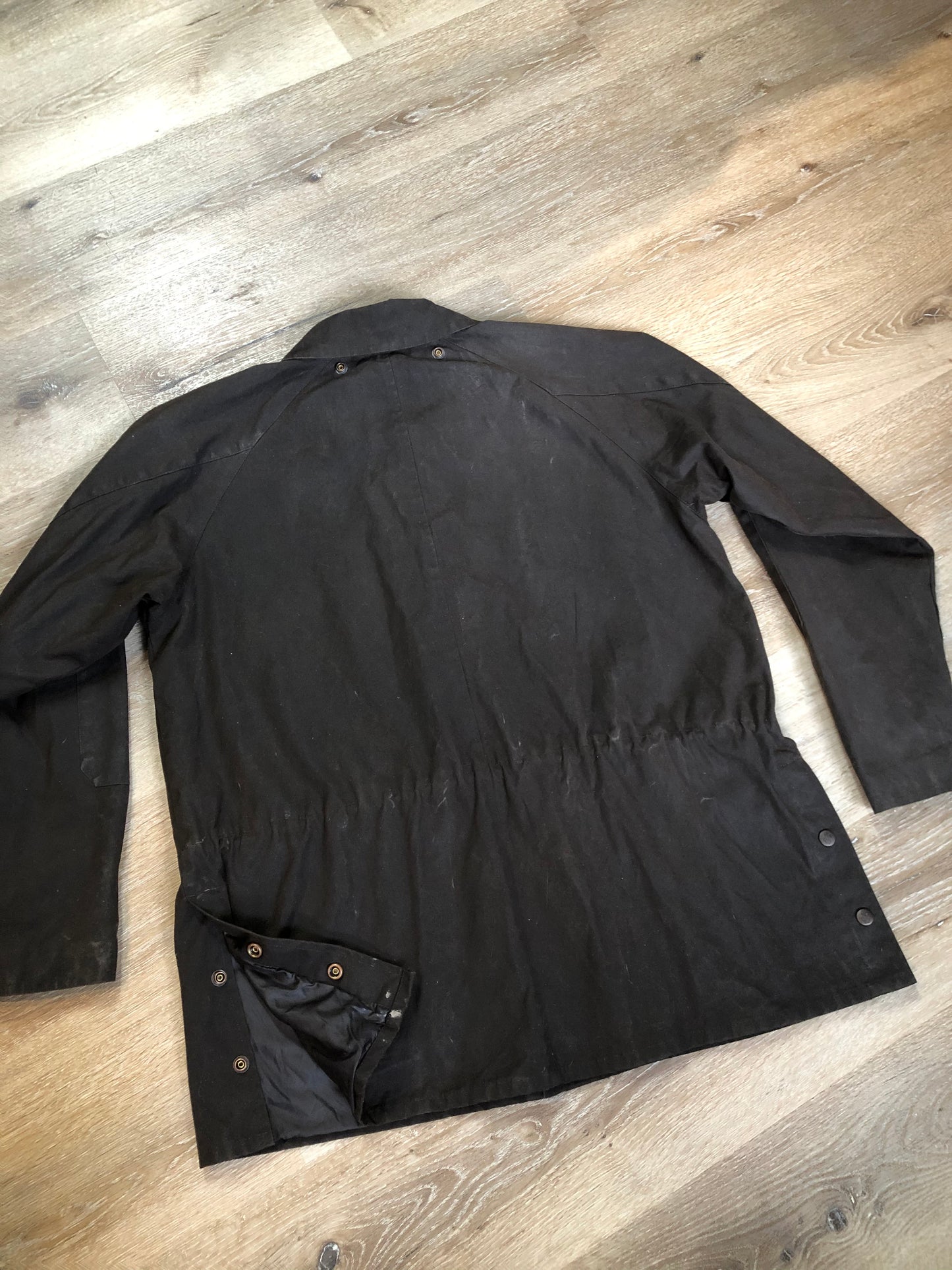 Kingspier Vintage - Outback Trading Co brown cotton oilskin rancher jacket with double snap closures, two snap flap pockets, one inside zip pocket, lightweight lining and drawstring at the waist. Fits large.