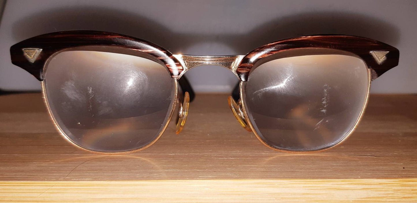 Extremely rare vintage redwood & gold American Optical Sirmont combination eyeglasses made famous by Malcolm X, SOLD