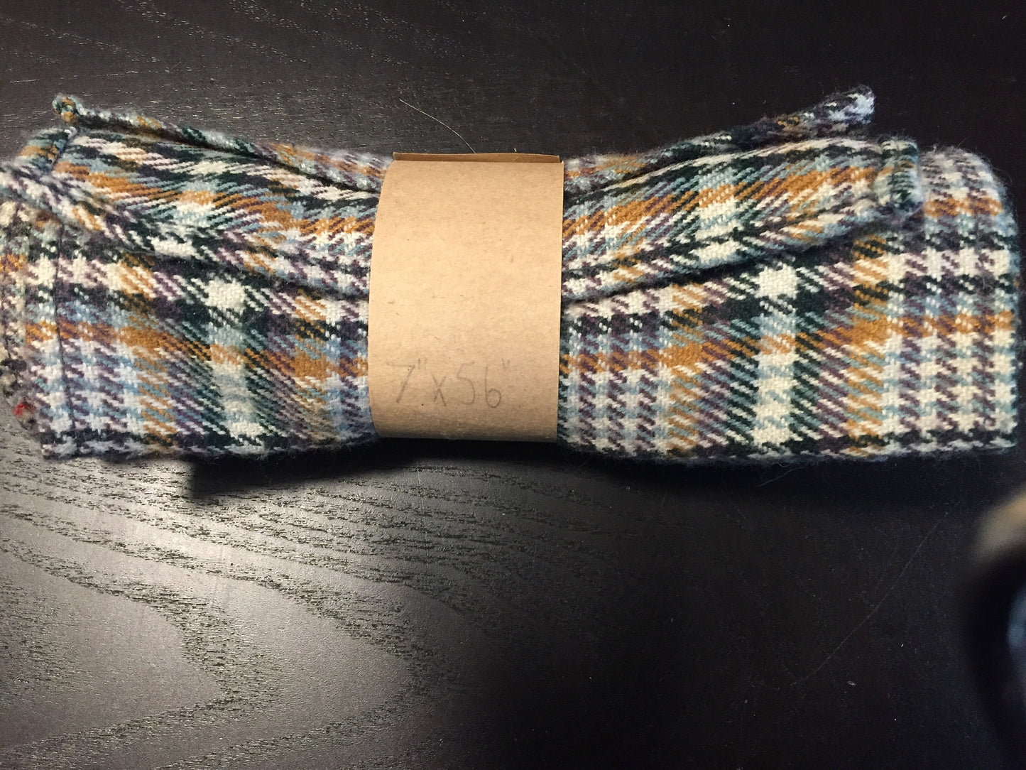 Multi-coloured plaid scarf. Wool blend, measures 7x56 inches.