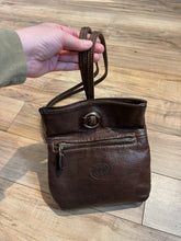 Load image into Gallery viewer, Vintage Roots brown leather crossbody/ knapsack, with two shoulder straps which can we worn as a knapsack or unclipped and worn as a cross body bag, one outer zip pocket and one main inner compartment.
