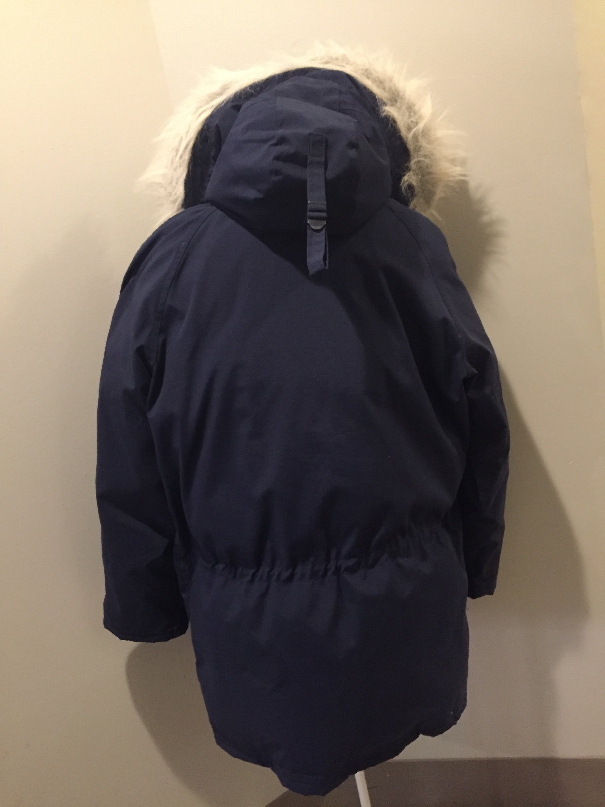 Kingspier Vintage - Rare Snow Goose parka from the 1970’s/1980’s (former name of Canada Goose) in navy with leather details and fur trimmed hood, slash pockets, flap pockets, zipper and button closures, “Snow Goose” patch on the front pocket, orange lining. Made in Canada. Size 40M. 